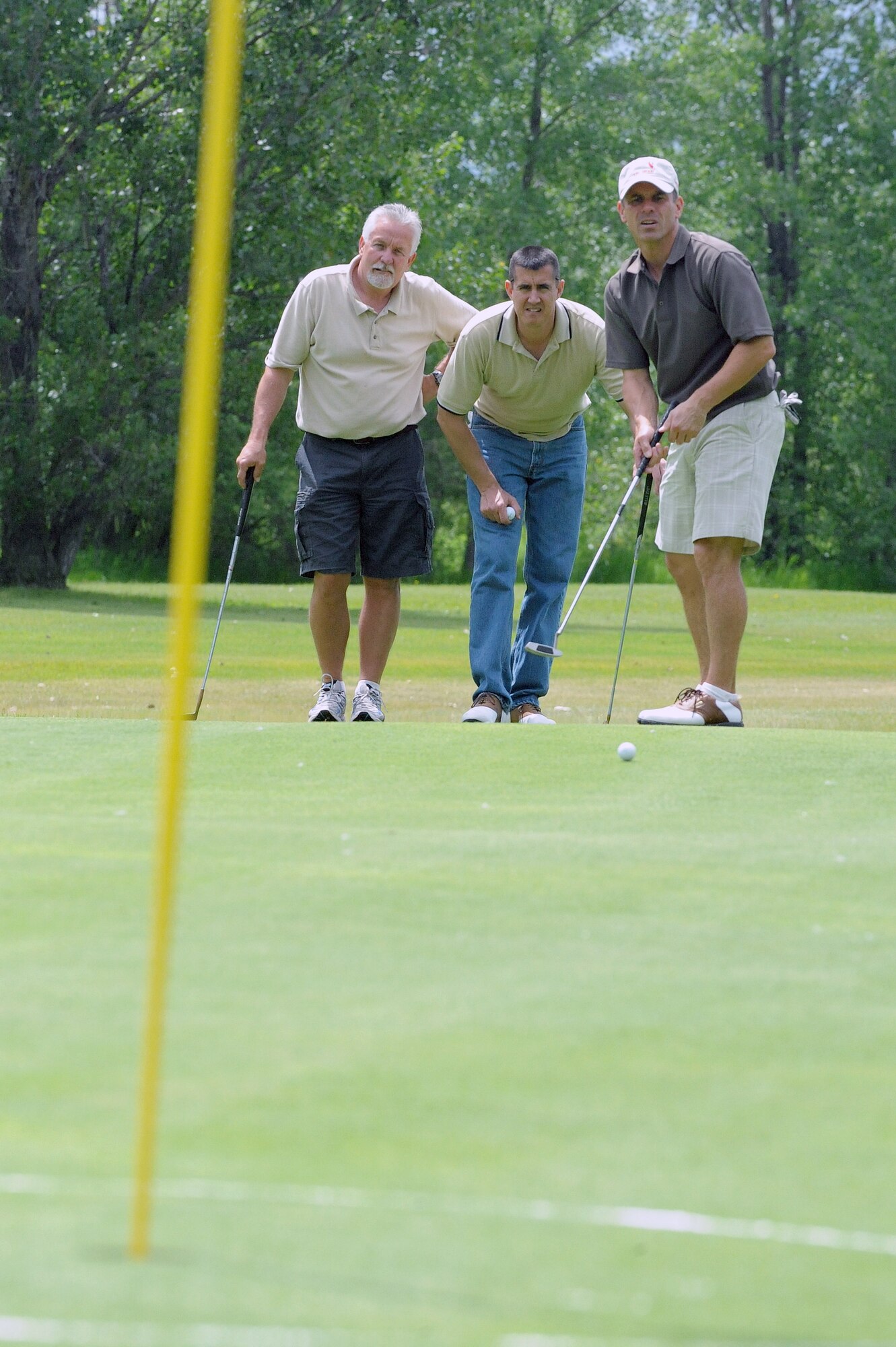 Rich Stahlberg, Capt Patrick Cain, 319th Maintenance Group and Master Sgt. Jim Gantar, 319th Communication Squadron (left to right) anxiously await the outcome of a putt June 21 during the Military Affairs Committee Golf Tournament at Grand Forks Air Force Base, N.D. The MAC Golf Tournament is an annual golf scramble consisting of two tournaments, one on Grand Forks AFB and one in the city of Grand Forks. Each four-man team is made up of both base personnel and members of the Grand Forks community. The event has been taking place since the 1980’s and continues to be a unique way for base and community members to interact. 