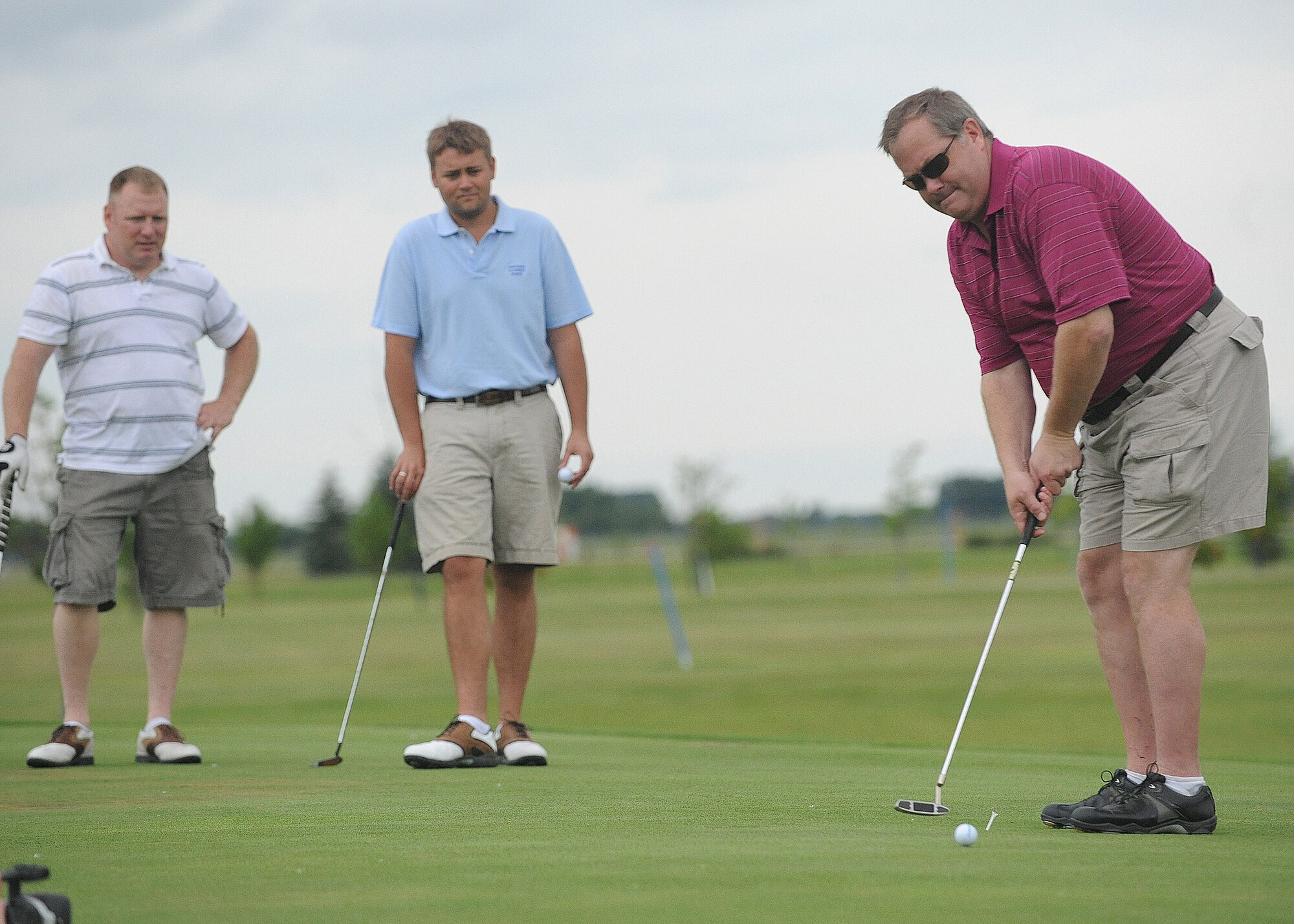 Brian Goodman attempts a putt while his teammates, Bob Dusso (left) and Tech. Sgt. Paul Lovelace, 319th Maintenance Group (right), watch June 21 during the Military Affairs Committee Golf Tournament at Grand Forks Air Force Base, N.D. The MAC Golf Tournament is an annual golf scramble consisting of two tournaments, one on Grand Forks AFB and one in the city of Grand Forks. Each four-man team is made up of both base personnel and members of the Grand Forks community. The event has been taking place since the 1980’s and continues to be a unique way for base and community members to interact. 