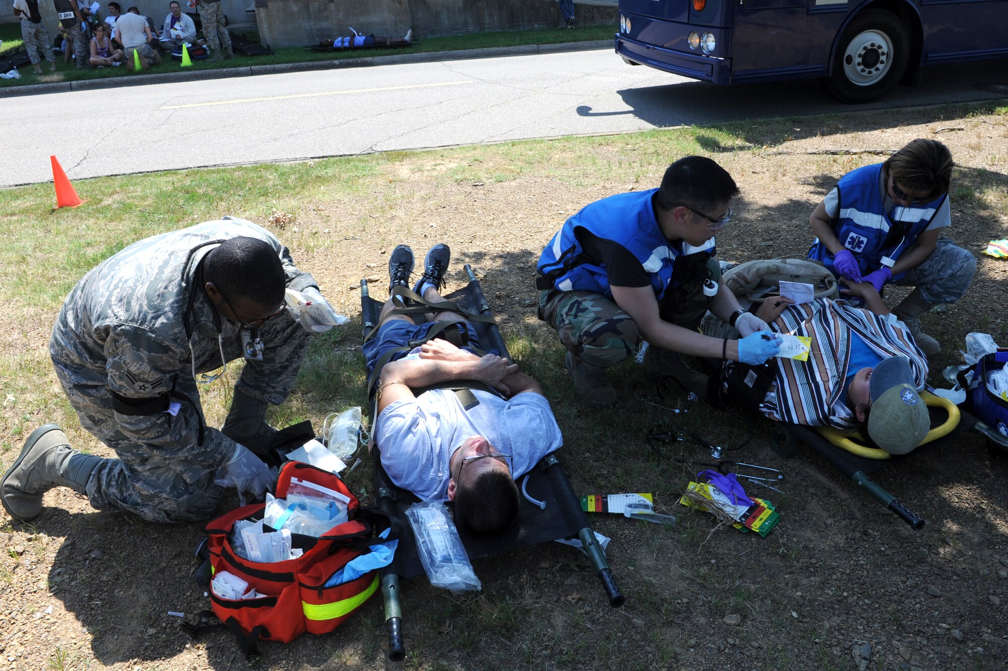 Personnel from the 19th Medical Group treat people with simulated injuries June 18 during an all-hazards response training exercise. The support of the community was shown by the willingness of the civilian volunteers to participate in the exercise. (U.S. Air Force photo by Senior Airman Ethan Morgan)