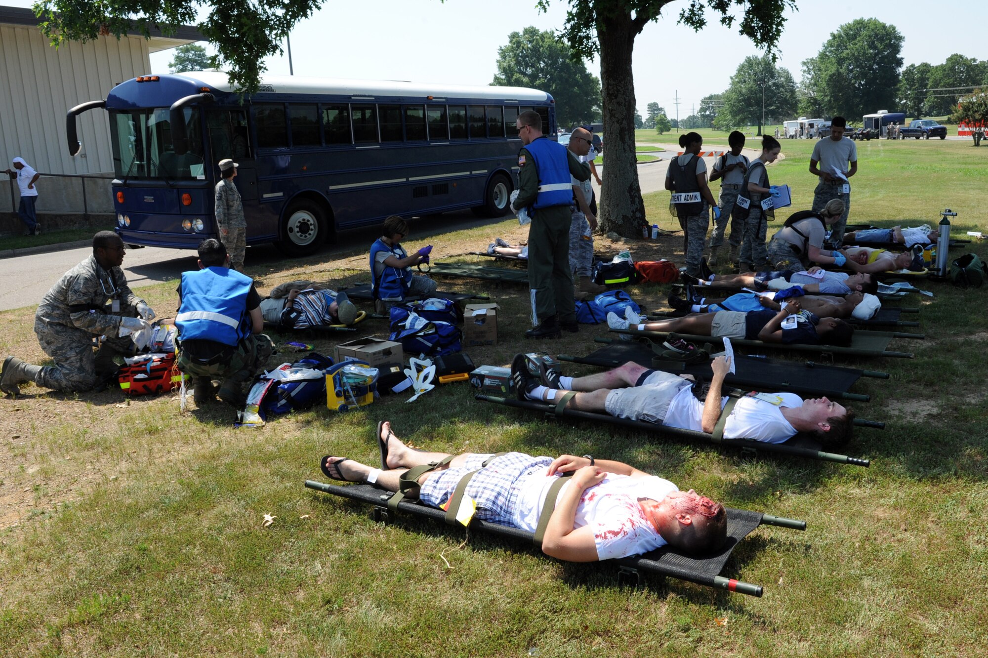 Members of Team Little Rock treat people with simulated injuries June 18 during a 19th Medical Group exercise. The routine exercise tests the 19th MDG’s response time to emergency situations. (U.S. Air Force photo by Senior Airman Ethan Morgan)