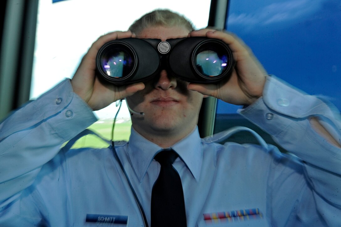 ELLSWORTH AIR FORCE BASE, S.D. – Airman 1st Class Jakob Schmitt, 28th Operations Support Squadron air traffic controller, views the flight line through binoculars, June 21. Air traffic controllers check for animals or vehicles that may be on the flight line prior to an aircraft taking off or landing. (U.S. Air Force photo/Airman 1st Class Matthew Flynn)