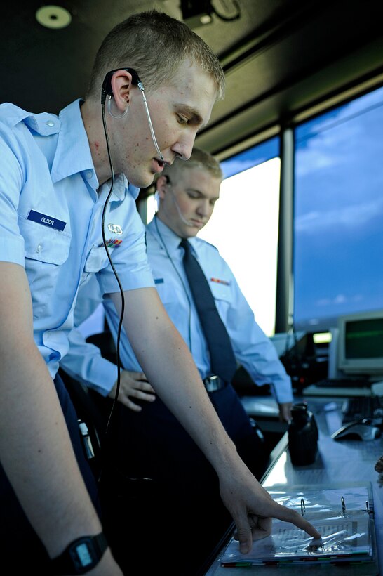 ELLSWORTH AIR FORCE BASE, S.D. – (Front) Airman 1st Class William Olson gives a position relief briefing to Airman 1st Class Jakob Schmitt, June 21.  Both Airmen are air traffic controllers assigned to the 28th Operations Support Squadron.  The briefing updates the next shift of personnel on the events currently taking place to ensure continuity between shift changes. (U.S. Air Force photo/Airman 1st Class Matthew Flynn)