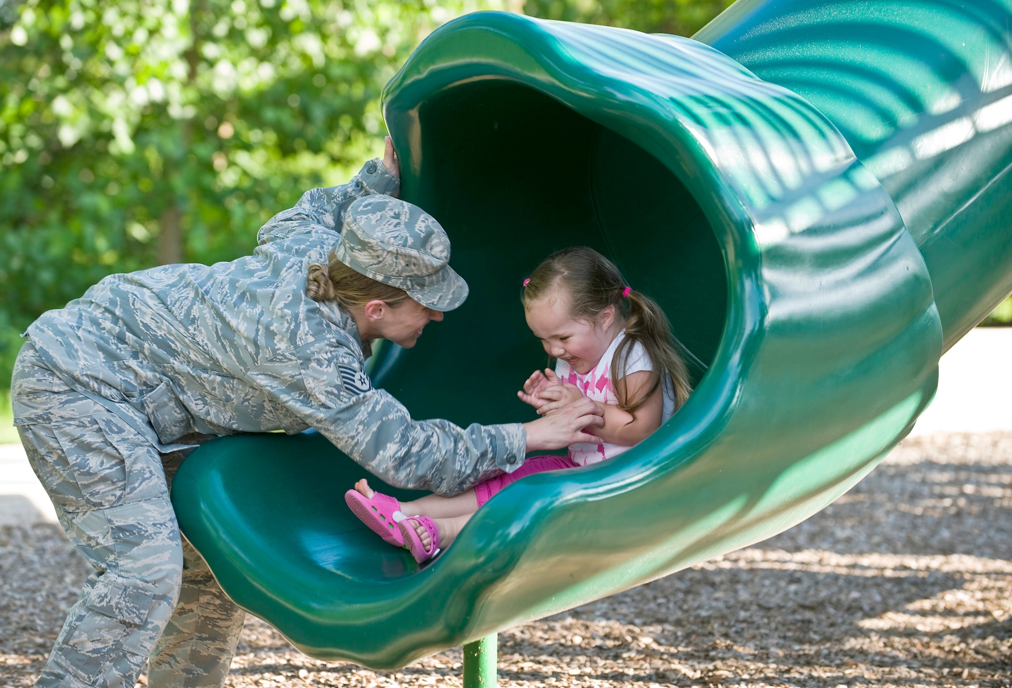 Tech. Sgt. Christina Gamez catches her daughter, Ava, while sliding at their neighborhood park. (U.S. Air Force photo/Staff Sgt. Bennie J. Davis III)