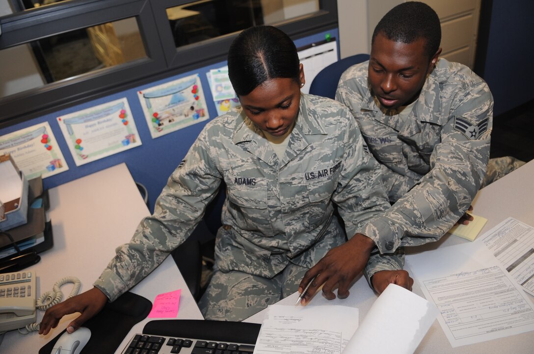 Senior Airmen Ashley Adams and Brandon Andrews, 316th Force Support Squadron military personnel section customer service representative, update the military personnel data system at Joint Base Andrews, Md. June 22, 2010.  MPS is responsible for upkeeping personnel records and customer support by personnel actions. (U.S. Air Force photo by Senior Airman Melissa V. Brownstein) 