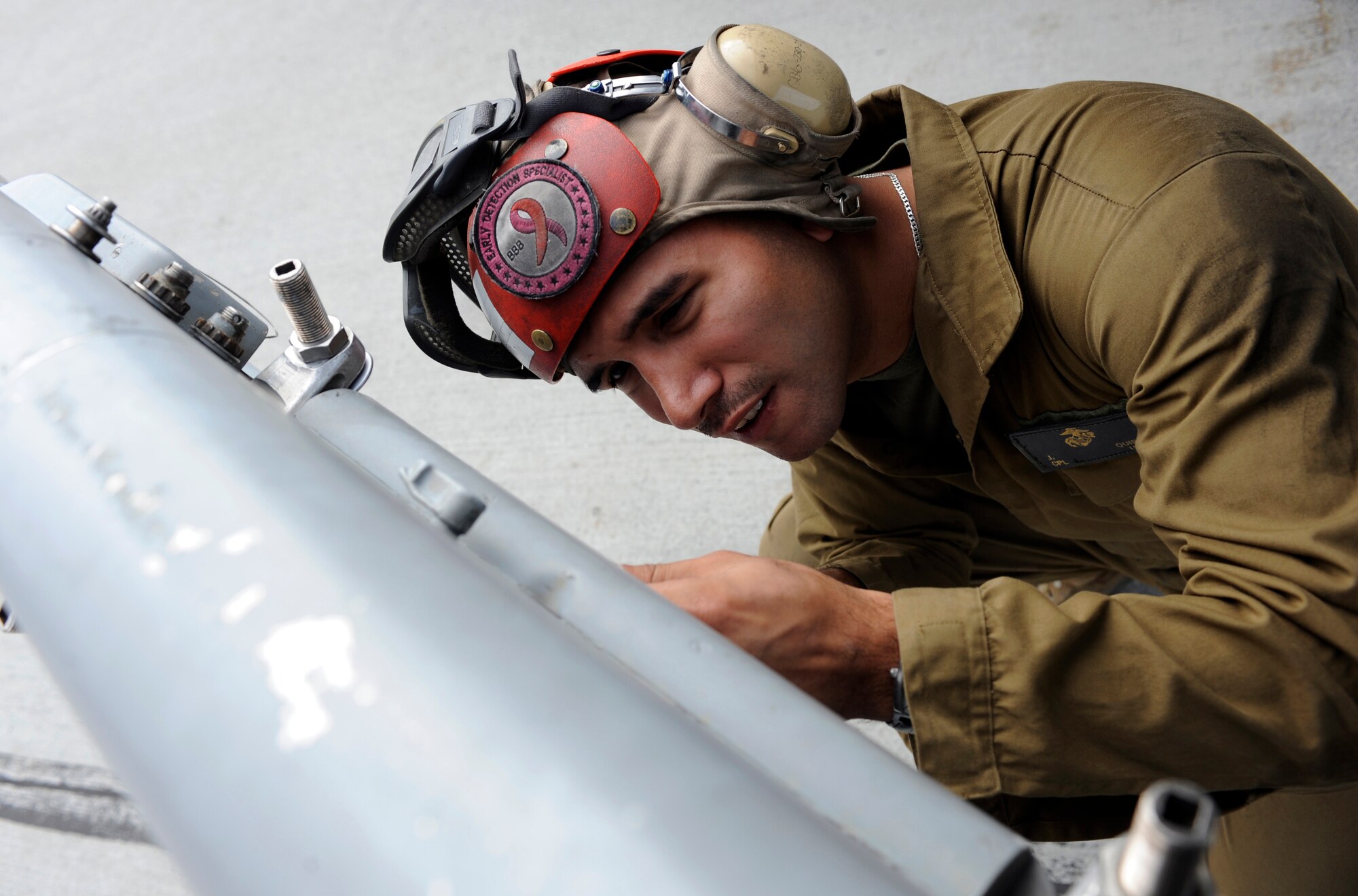 Marine Corps Cpl. Joseph Quiroz opens a panel to ensure its operability June 15, 2010, Eielson Air Force Base, Alaska. Corporal Quiroz does walk around checks to make sure flight and ordinance systems are safe for flight. Corporal Quiroz is an ordnance technician assigned to VMA-214, Marine Corps Air Station, Yuma, Ariz. (U.S. Air Force photo/Airman 1st Class Willard E. Grande II)