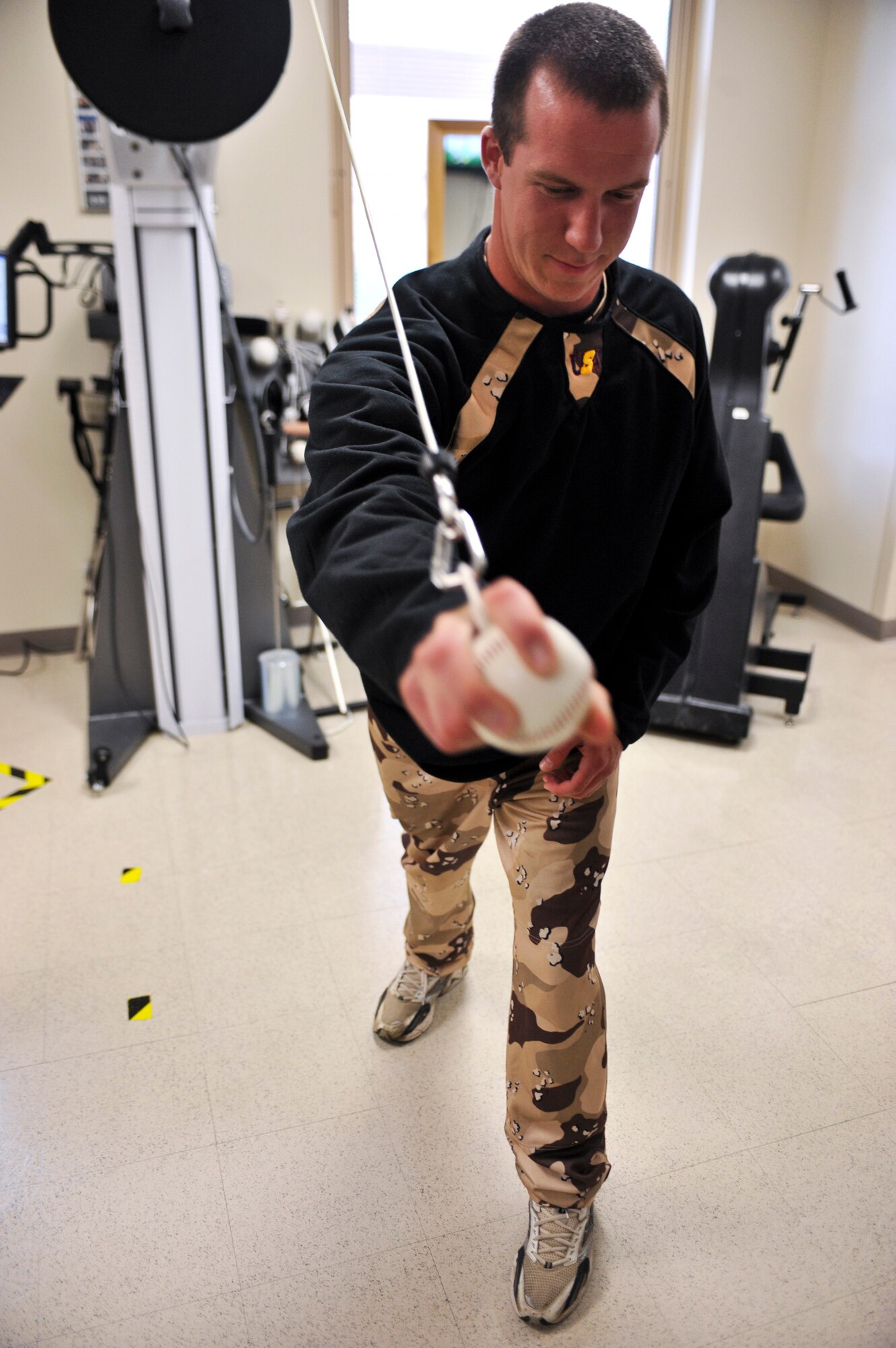 JOINT BASE ELMENDORF-RICHARDSON, Alaska – A Heroes of the Diamond member uses a piece of the 3rd Medical Group’s rehabilitation equipment, June 18, that is normally used to help pitchers and golfers recoup from injuries. While here on their 12-day baseball tour through several towns and cities in Alaska, the HOD took time to visit the 3rd MDG. (Air Force photo by Airman 1st Class Christopher Gross)