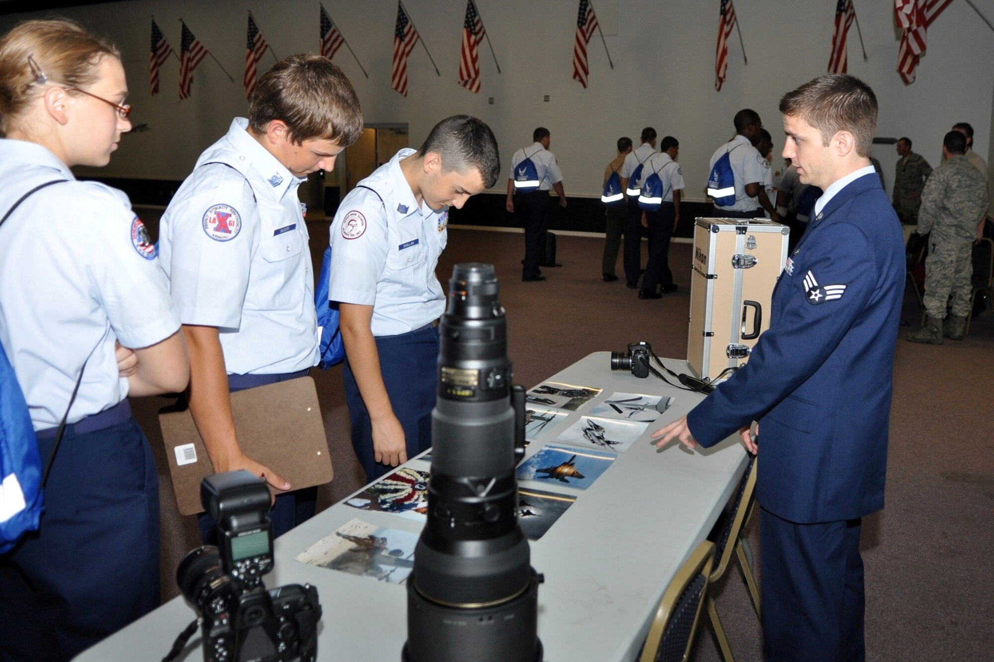 Senior Airman Chad Warren, from the 2nd Bomb Wing Public Affairs office, promotes the benefits of choosing public affairs as a career choice during the JROTC Open House held at Barksdale Air Force Base, La., June 17, 2010. Airmen from over 40 Air Force Specialty Codes (AFSC) at Barksdale were represented during the open house to explain career options to the cadets. An AFSC is an alphanumerical code used by the United States Air Force to identify an Air Force Specialty (AFS) or in layman’s term, a type of job or career field. (U.S. Air Force photo/Tech. Sgt. Jeff Walston)