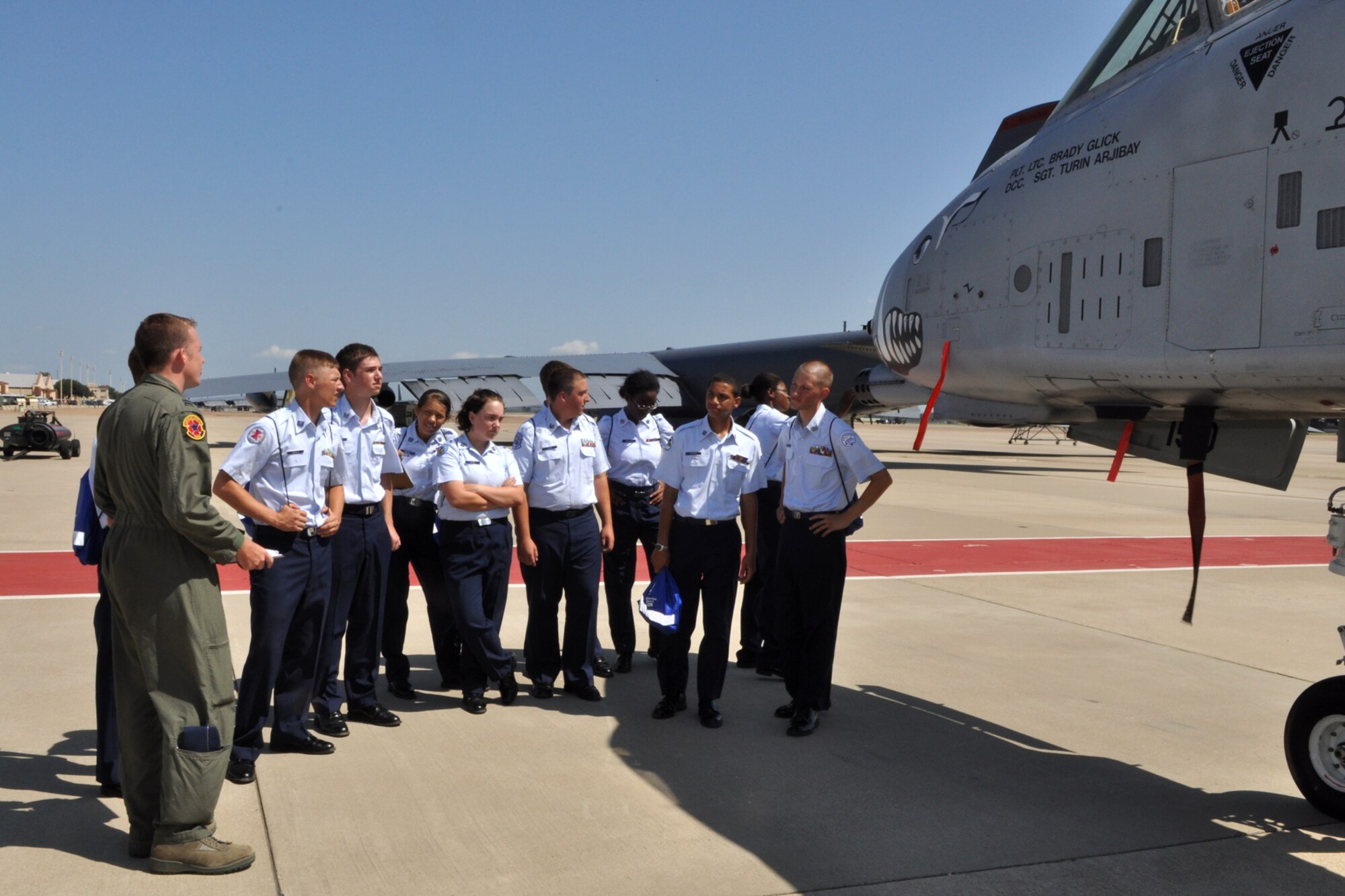 Capt. Stephen Dzialo, lead coordinator for the JROTC Open House, briefs cadets on the capabilities of the A-10 Thunderbolt II and the B-52 Stratofortress at Barksdale Air Force Base, La., June 17, 2010. Captain Dzialo is attached to the 2nd Operations Support Squadron at Barksdale AFB. Airmen from over 40 Air Force Specialty Codes (AFSC) at Barksdale were represented during the open house to explain career options to the cadets. An AFSC is an alphanumerical code used by the United States Air Force to identify an Air Force Specialty (AFS) or in layman’s term, a type of job or career field. (U.S. Air Force photo/Tech. Sgt. Jeff Walston)
