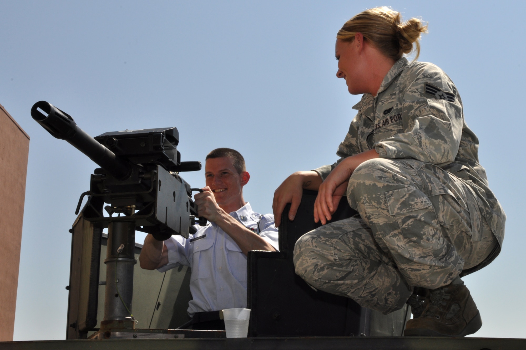 Senior Airman Brittany Smith, armorer, 2nd Security Forces Squadron familiarizes Cadet Christopher Lanphier with the Mark 19 grenade launcher outside Hoban Hall at Barksdale Air Force Base La., June 17, 2010.. The Mk 19 is a belt fed, blowback operated, air cooled, crew serve, fully automatic weapon that fires 40 mm grenades at a cyclic rate if 325 to 375 rounds per minute. Cadet Lanphier is attached to AF JROTC Unit LA-20025 at Acadiana High School in Lafayette, La. Airmen from over 40 Air Force Specialty Codes (AFSC) at Barksdale were represented during the open house to explain career options to the cadets. An AFSC is an alphanumerical code used by the United States Air Force to identify an Air Force Specialty (AFS) or in layman’s term, a type of job or career field. (U.S. Air Force photo/Tech. Sgt. Jeff Walston)


