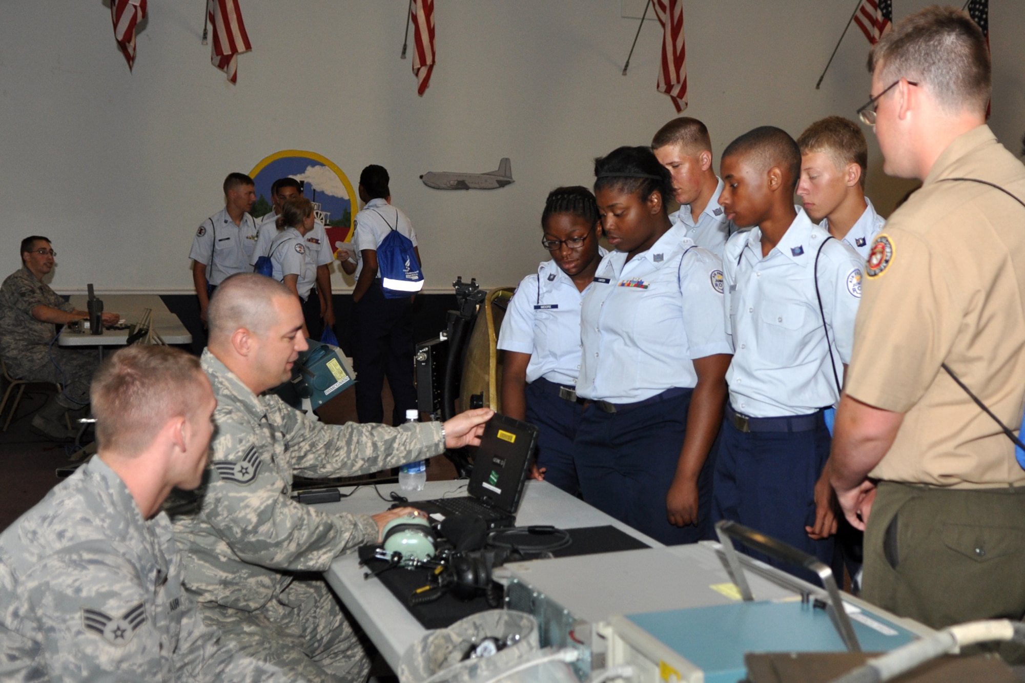 Staff Sgt. James Isenhour and Senior Airman Brennan Mosso explain communication, navigation and offensive avionics to a group of JROTC cadets in Hoban Hall during the JROTC Open House held at Barksdale Air Force Base, La., June 17, 2010.  Sergeant Isenhour is a comm nav/mission systems craftsman and Airman Mosso is a comm nav/mission systems journeyman. Both Airmen are assigned to the 2nd Maintenance Squadron at Barksdale AFB. Airmen from over 40 Air Force Specialty Codes (AFSC) at Barksdale were represented during the open house to explain career options to the cadets. An AFSC is an alphanumerical code used by the United States Air Force to identify an Air Force Specialty (AFS) or in layman’s term, a type of job or career field. (U.S. Air Force photo/Tech. Sgt. Jeff Walston)
