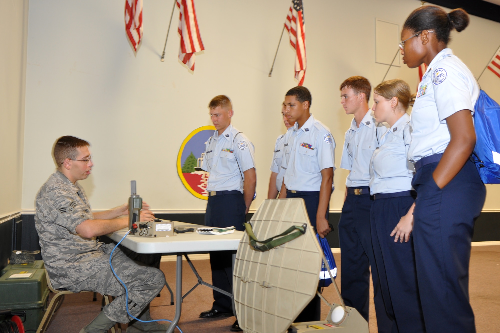 Senior Airman Jeffrey Landers, RF systems technician, 2nd Communications Squadron, explains RF transmission systems, radios, encrypted signals and satellite communications to a group of JROTC cadets in Hoban Hall during part of the JROTC Open House held at Barksdale Air Force Base, La., June 17, 2010. Airmen from over 40 Air Force Specialty Codes (AFSC) at Barksdale were represented during the open house to explain career options to the cadets. An AFSC is an alphanumerical code used by the United States Air Force to identify an Air Force Specialty (AFS) or in layman’s term, a type of job or career field. (U.S. Air Force photo/Tech. Sgt. Jeff Walston)