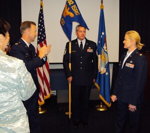 Col. Aldon E. Purdham, commander of the 692nd Intelligence, Surveillance and Reconnaissance Group, Hickam Air Force Base, Hawaii, gives a round of applause to Lt. Col. Ramona Fulkerson, the first commander of the newly activated 792nd Intelligence Support Squadron, during an activation ceremony June 4. The 792nd ISS provides critical communications, computer, maintenance and personnel support to other squadrons in the group. (U.S. Air Force photo by Staff Sgt. Mark Baker)