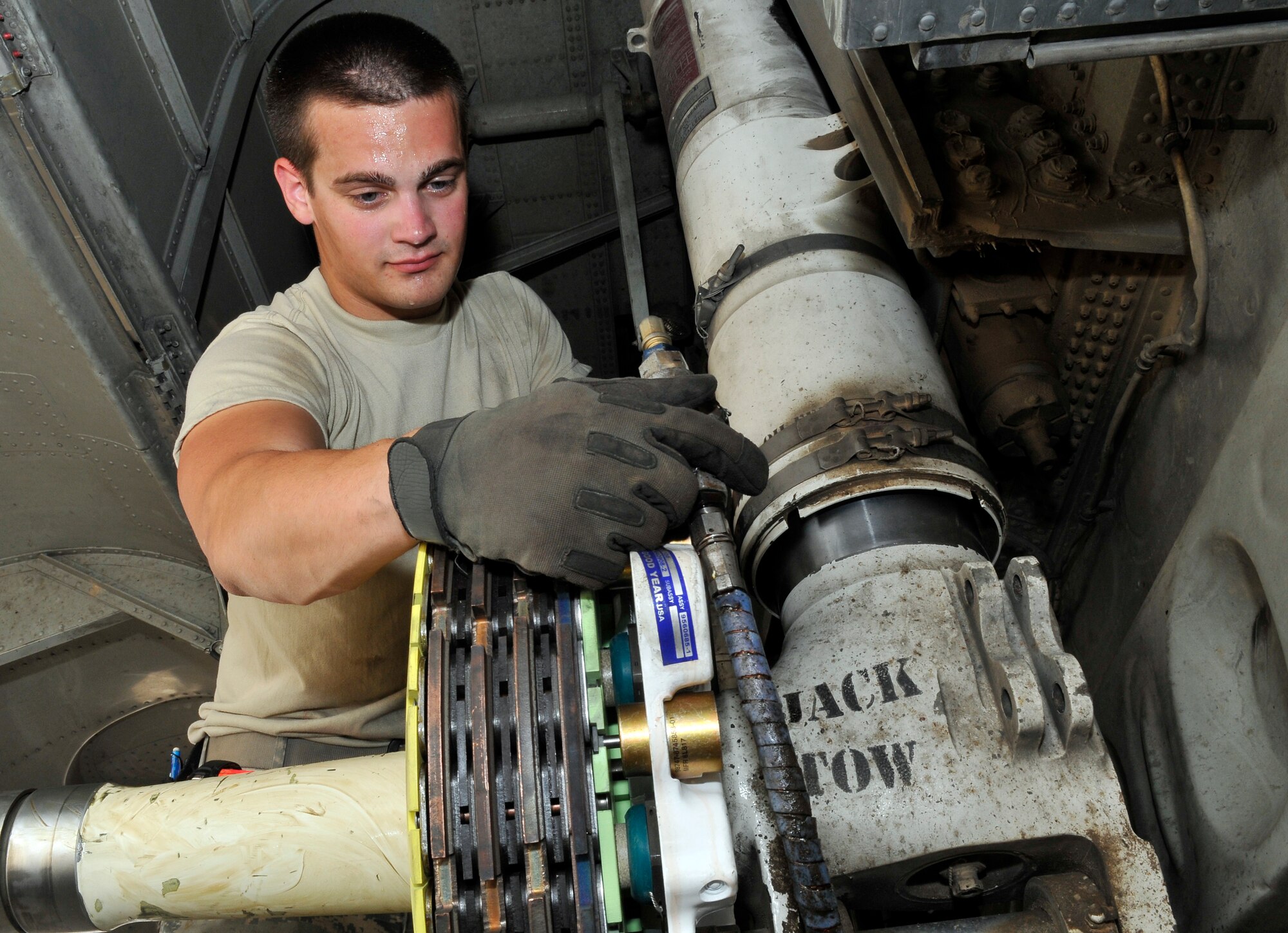 Senior Airman Joshua Arrington, 777th Expeditionary Airlift Maintenance Unit crewchief, aligns a C-130 Hercules’s brake assembly after a brake change June 18, 2010, Joint Base Balad, Iraq. The 777th EAMU produces approximately 950 sorties a month. Airman Arrington is deployed from Little Rock Air Force Base, Ark. (U.S. Air Force photo\Staff Sgt. Phillip Butterfield)
