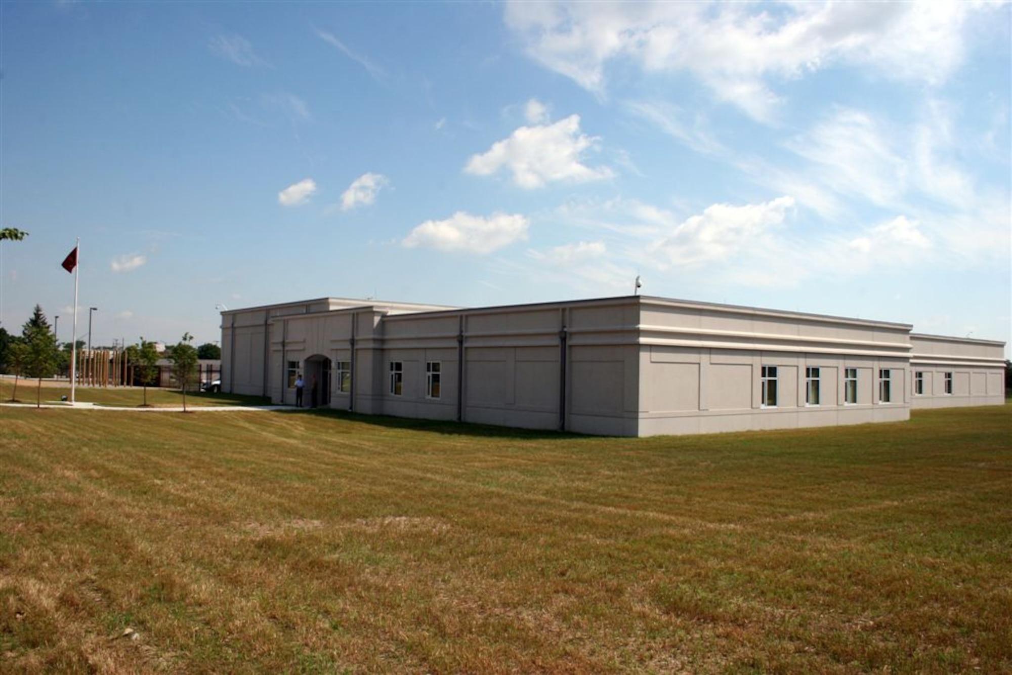 Naval Facilities Engineering Command Midwest partnered with Dayton-based Butt Construction in 2009 to build a $10-million reserve center and vehicle maintenance facility for the 180 Marines of Military Police Company "C," Marine Logistics Group, who deploy to perform security and military law enforcement duties around the world.  The facility was opened June 18 at a ribbon cutting ceremony held here (Courtesy photo by Bill Couch.) 