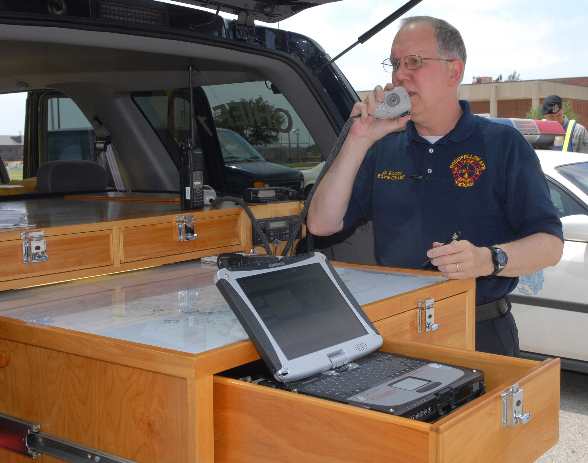 John Foote, fire chief, takes control of the disaster scene at the clinic after a simulated tornado touched down June 17. The wing-wide natural disaster exercise provided an opportunity to ensure everyone knows what to do, teach those that don't and identify areas that could be improved. (U.S. Air Force photo/Lou Czarnecki)