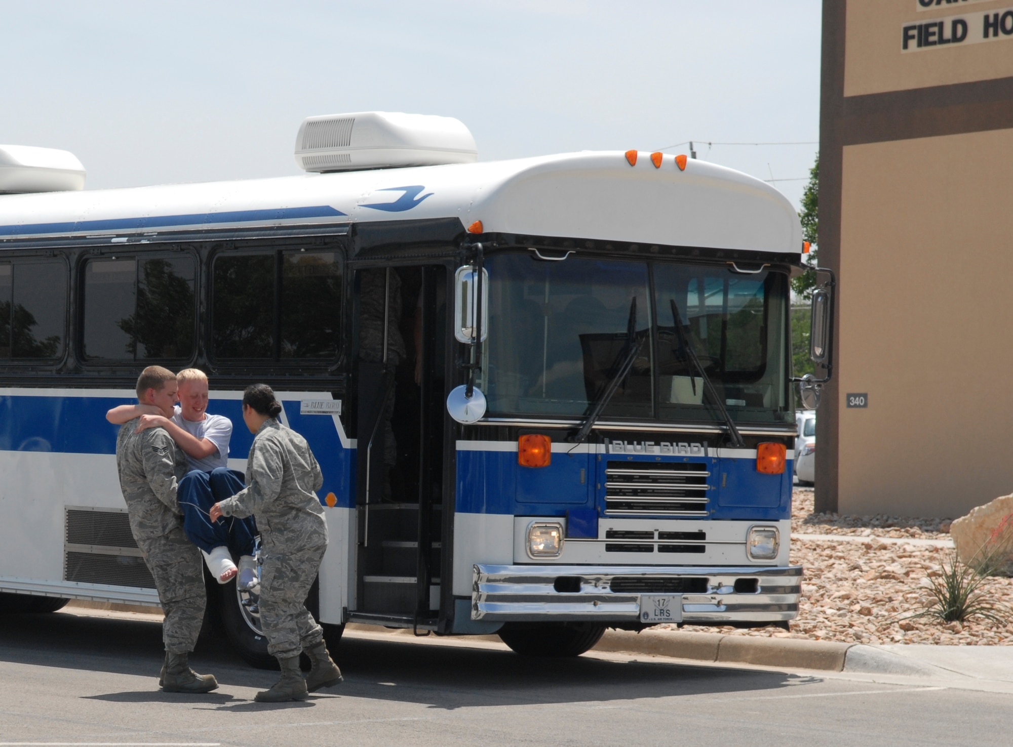 Airmen from the 17th Medical Group help the wounded into their alternate medical facility, the Carswell Fieldhouse, during a wing-wide natural disaster exercise June 17. A simulated tornado landing at the clinic left medical personel to relocate and get their AMF to operational status to treat those moulaged with cuts and bruises. (U.S. Air Force photo/Lou Czarnecki)