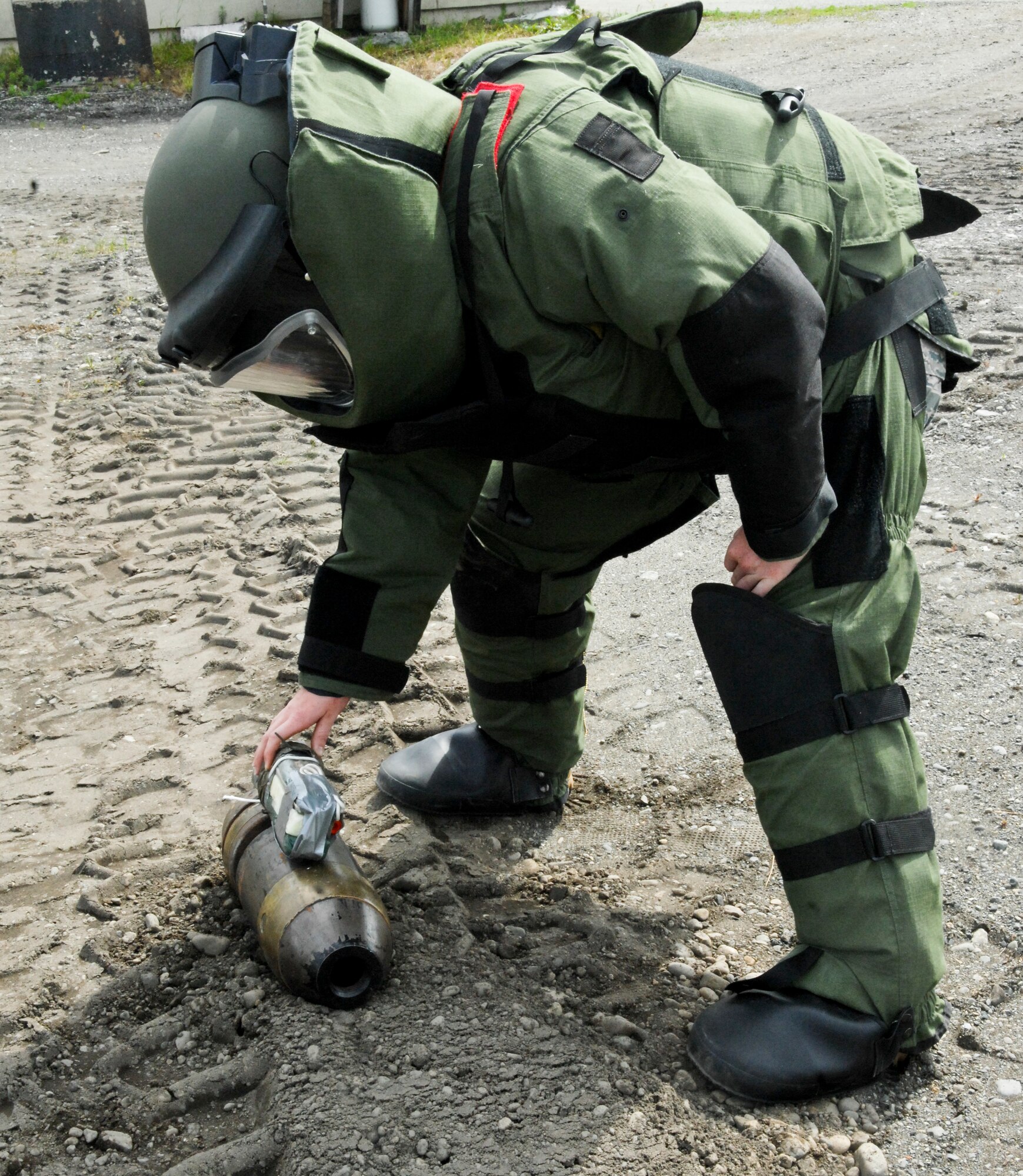 Airman 1st Class Monica Benzien, 3rd Civil Engineer Squadron explosive ordinance disposal journeyman, works on a 75-pound simulated explosive during a training exercise, June 17. EOD members train weekly on proper disposal of ordinance. (Air Force photo by Airman 1st Class Jack Sanders)