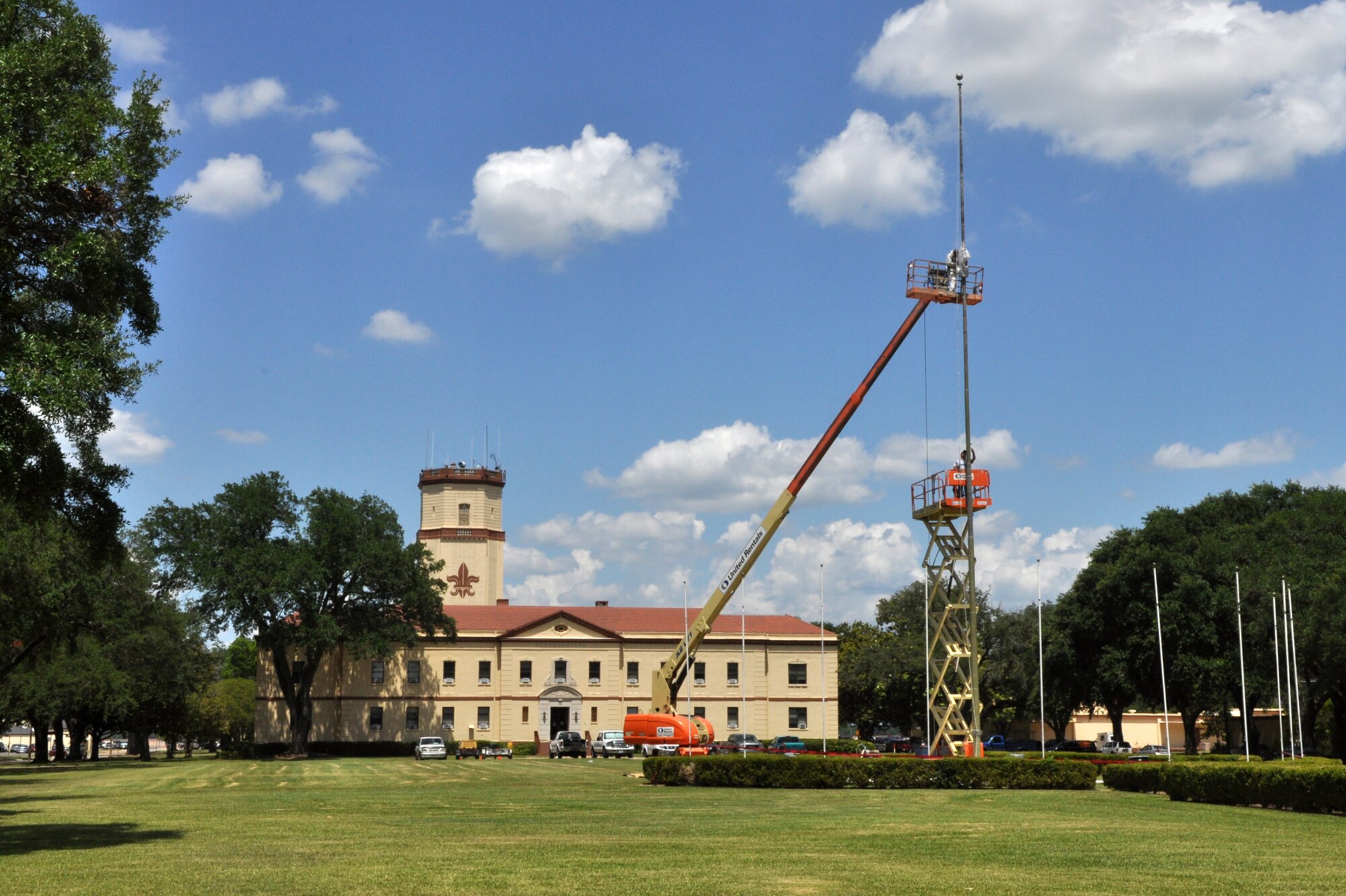 Workers chip paint and prepare the flagpole in from of the 2nd Bomb Wing Headquarters building for a new coat of paint at Barksdale Air Force Base, La., June 17, 2010. (U.S. Air force photo/Tech. Sgt. Jeff Walston)