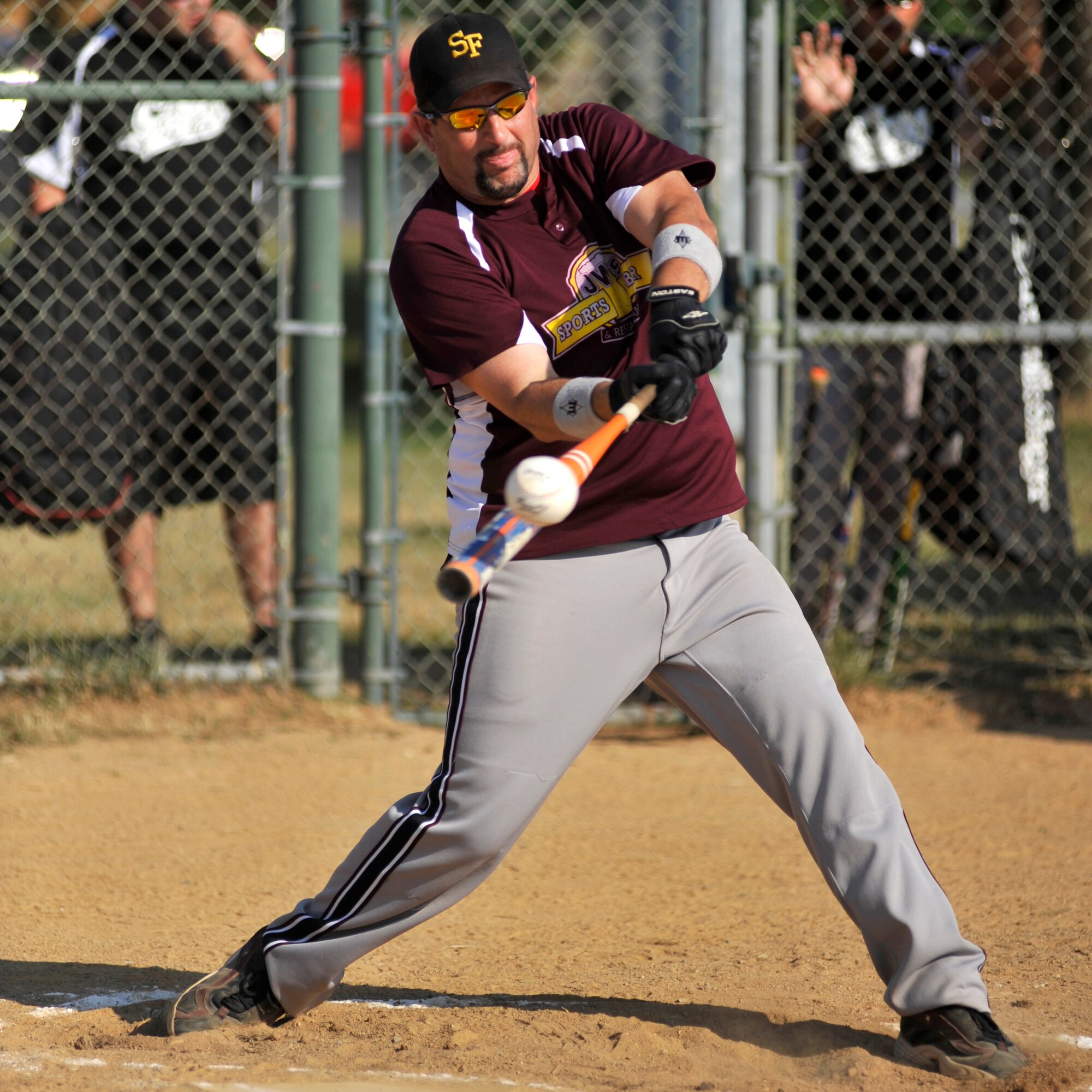 Rick Barker, 436th Security Forces Squadron pitcher, blasts an RBI-triple during an American League softball game against the 436th Aerial Port Squadron at the base softball field on Dover Air Force Base, Del., June 21, 2010. Barker went 2-for-4 with three RBI and was the winning pitcher as the Cops defeated APS 11-7. (U.S. Air Force photo by Tech. Sgt. Chuck Walker/Released)