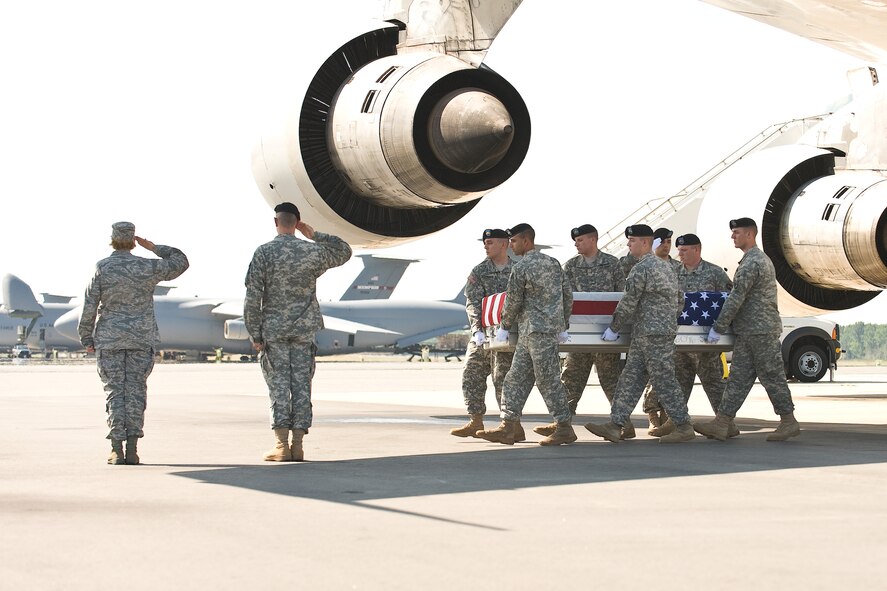 A U.S. Army carry team transfers the remains of Army Spc. Joseph D. Johnson, of Flint, Mich., at Dover Air Force Base, Del., June 18. Johnson was assigned to the 161st Engineer Support Company, 27th Engineer Battalion (Combat) (Airborne), 20th Engineer Brigade, 18th Airborne Corps, Fort Bragg, N.C. He died June 16 in North Kunduz, Afghanistan, of wounds suffered when insurgents attacked his unit with an improvised explosive device. (U.S. Air Force photo/Roland Balik) 
