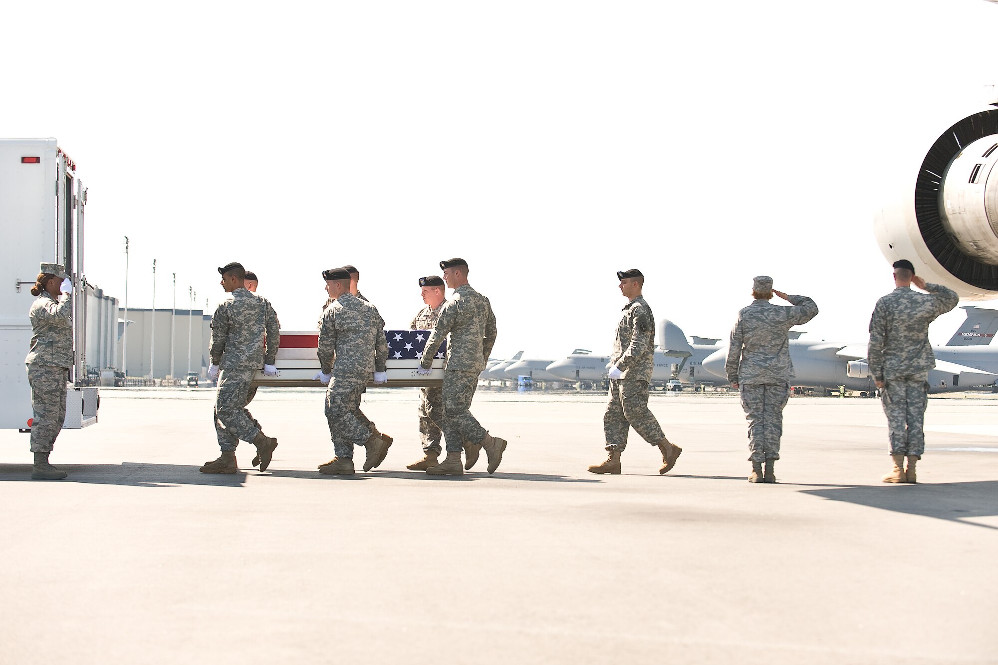 A U.S. Army carry team transfers the remains of Army Capt. Michael P. Cassidy, of Simpsonville, S.C., at Dover Air Force Base, Del., June 18. Capt. Cassidy was assigned to the 1st Battalion, 9th Field Artillery, 2nd Heavy Brigade Combat Team, 3rd Infantry Division, Fort Stewart, Ga. (U.S. Air Force photo/Roland Balik)