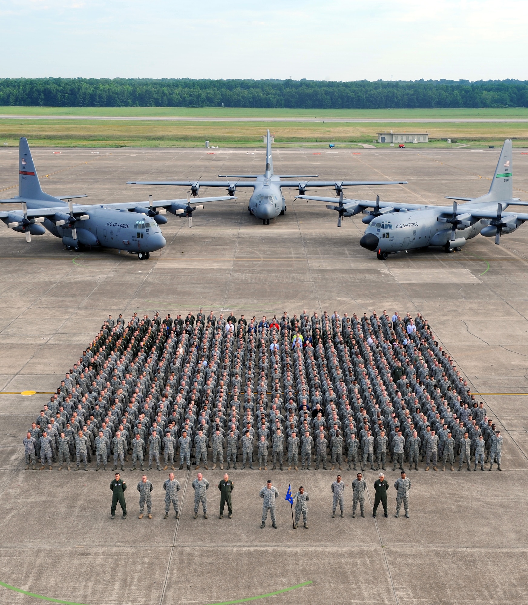 Nearly 800 19th Airlift Wing military and civilian Black Knights stood in formation together June 18 in front of a C-130E, H and J for a wing group photo. (U.S. Air Force photo by Senior Airman Chris Willis)