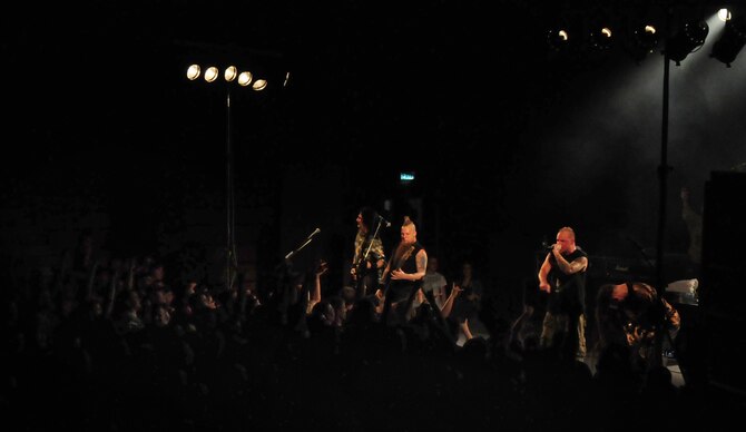 SPANGDAHLEM AIR BASE, Germany -- People from all around the base rush the stage June 10 in the Skelton Memorial Fitness Center as the heavy metal band Five Finger Death Punch played a free show. About 500 military members, friends and family filled the gymnasium just days after the band played at Rock am Ring, one of Germany’s largest music festivals. (U.S. Air Force photo/Staff Sgt. Heather Norris)