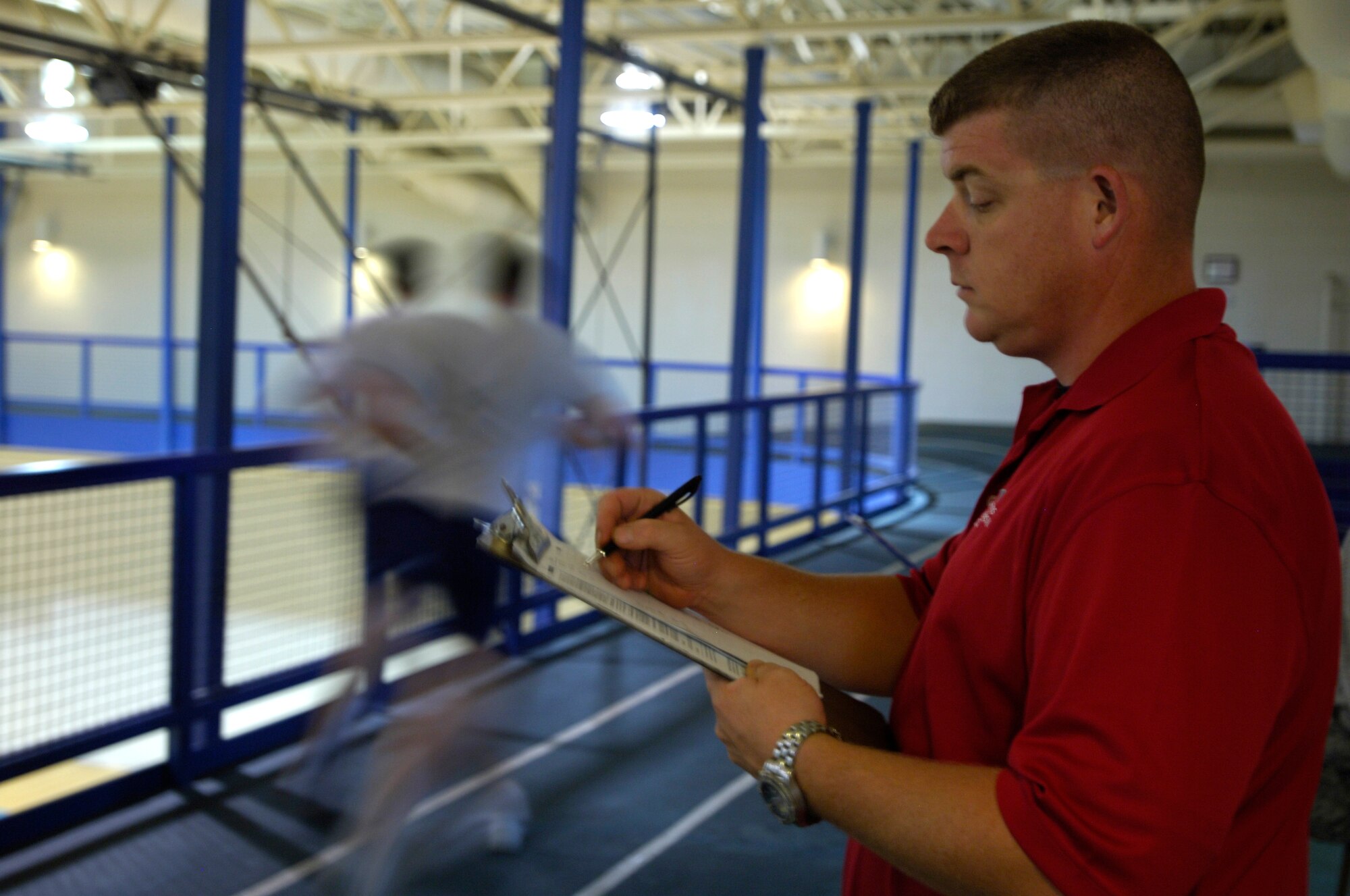 Glen A. Stallard, 22nd Force Support Squadron test administrator, records the number of laps done by Airmen taking the Air Force fitness test running portion June 18, 2010, McConnell Air Force Base, Kan. Mr. Stallard has administered approximately 400 tests to Team McConnell Airmen within the past month. (U.S. Air Force photo/Airman Armando A. Schwier-Morales)
