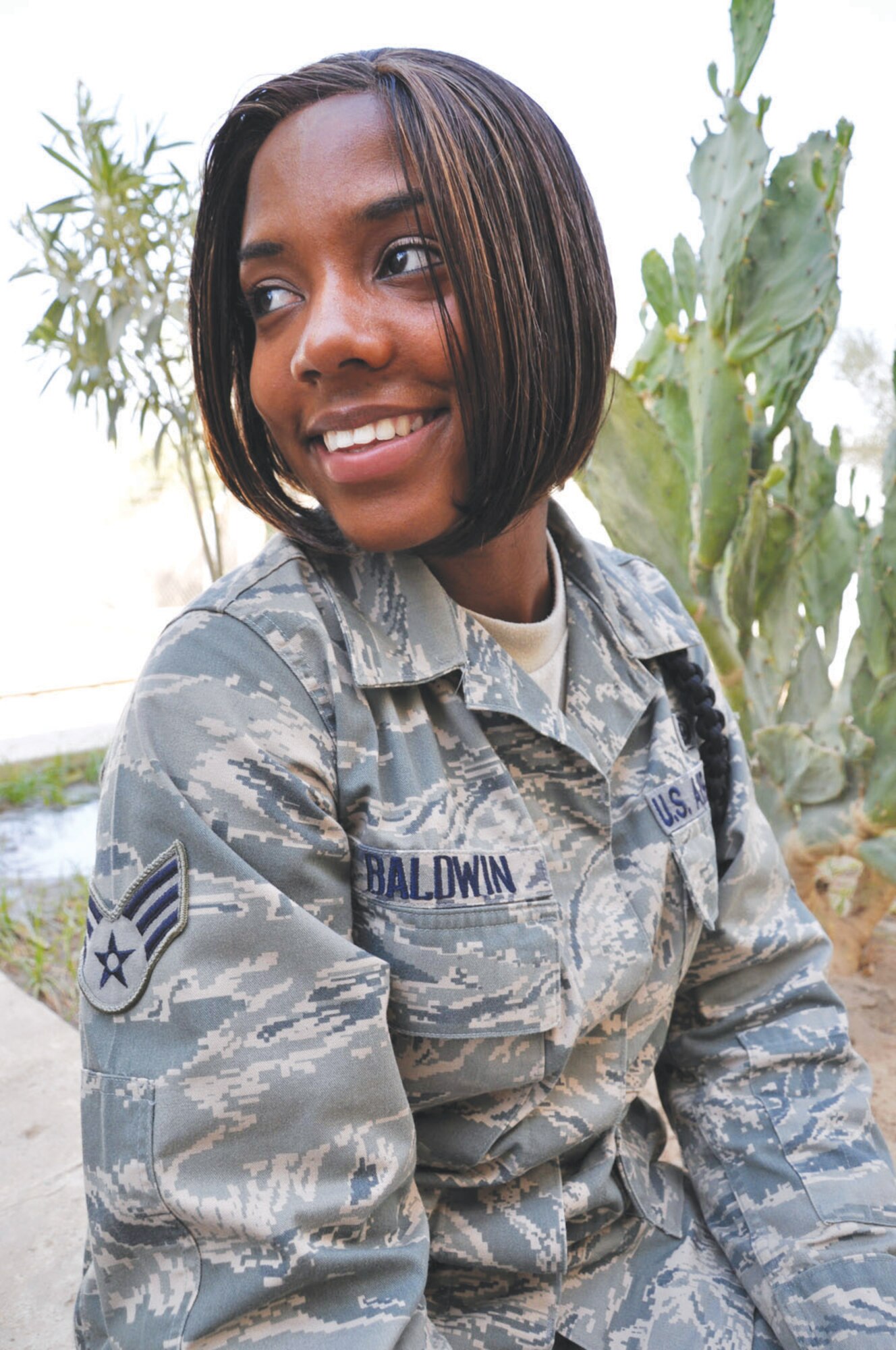 Senior Airman Raquel Baldwin, 447th Expeditionary Communications Squadron, Sather Air Base, Baghdad, takes a moment out of her hectic day to share a smile and reflect on her deployment experiences.  In addition to working in the Communications career field, Baldwin also enjoys writing poetry.  She currently has a collection of poetry on which she is working and plans to produce a book of poems in the near future. (U.S. Air Force photo by Tech. Sgt. Mike Edwards)