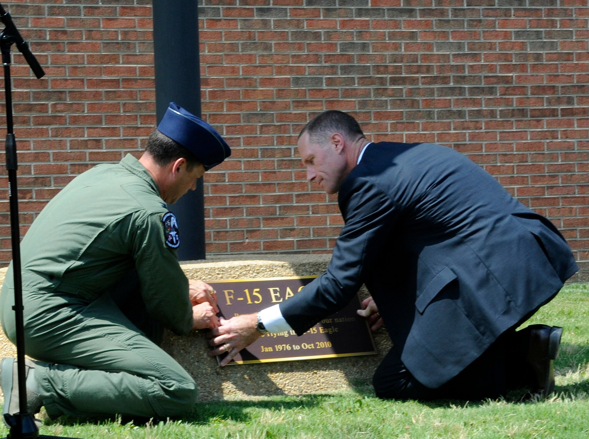 LANGLEY AIR FORCE BASE, Va. -- Air Force Reserve Brig. Gen. James Firth, director of Boeing's Newport News field office, and Col. Matt Molloy, 1st Fighter Wing commander, install the new F-15 Eagle plaque during the Boeing Plaque ceremony at 1 FW headquarters June 18. The ceremony was one of the many festivities held to bid farewell to the Langley F-15 Eagles and the 71st Fighter Squadron. (U.S. Air Force photo/Senior Airman Dana Hill)