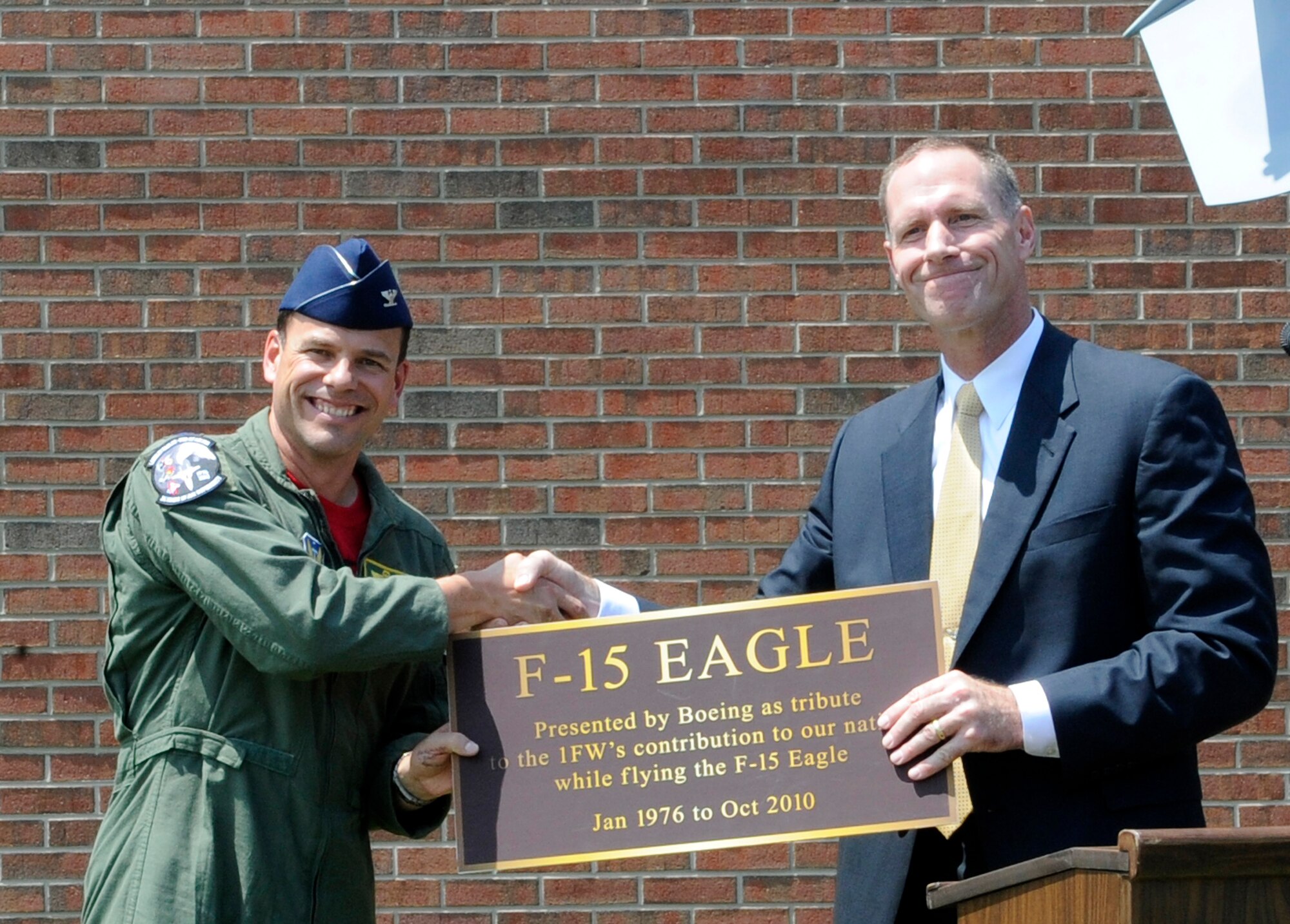 LANGLEY AIR FORCE BASE, Va. -- Air Force Reserve Brig. Gen. James Firth, director of Boeing's Newport News field office, presents Col. Matt Molloy, 1st Fighter Wing commander, with the new F-15 Eagle plaque during the Boeing Plaque ceremony at 1 FW headquarters June 18. The ceremony was one of the many festivities held to bid farewell to the Langley F-15 Eagles and the 71st Fighter Squadron. (U.S. Air Force photo/Senior Airman Dana Hill)