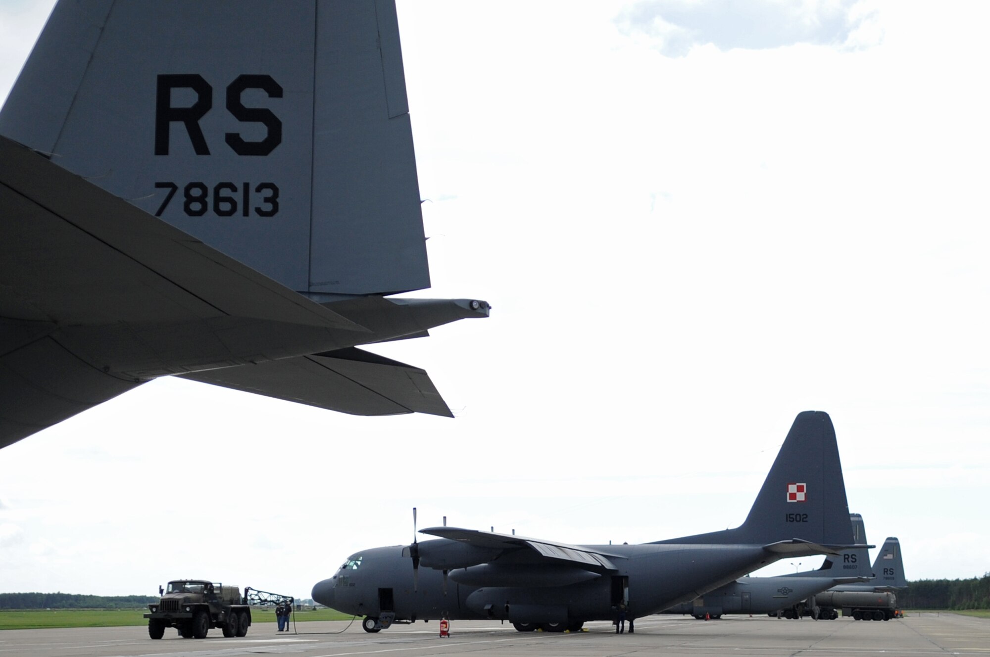A U.S. Air Force C-130J and a Poland Air Force C-130E park on the flightline during a visit on Powidz Air Base, Poland, June 21, 2010. The purpose of General Dillon's visit to Poland was to sign the letter designating the 86th AW and the 3rd Airlift Wing as 'sister wings' and to build partnerships. (U.S. Air Force photo by Airman 1st Class Grovert Fuentes-Contreras)(Released)