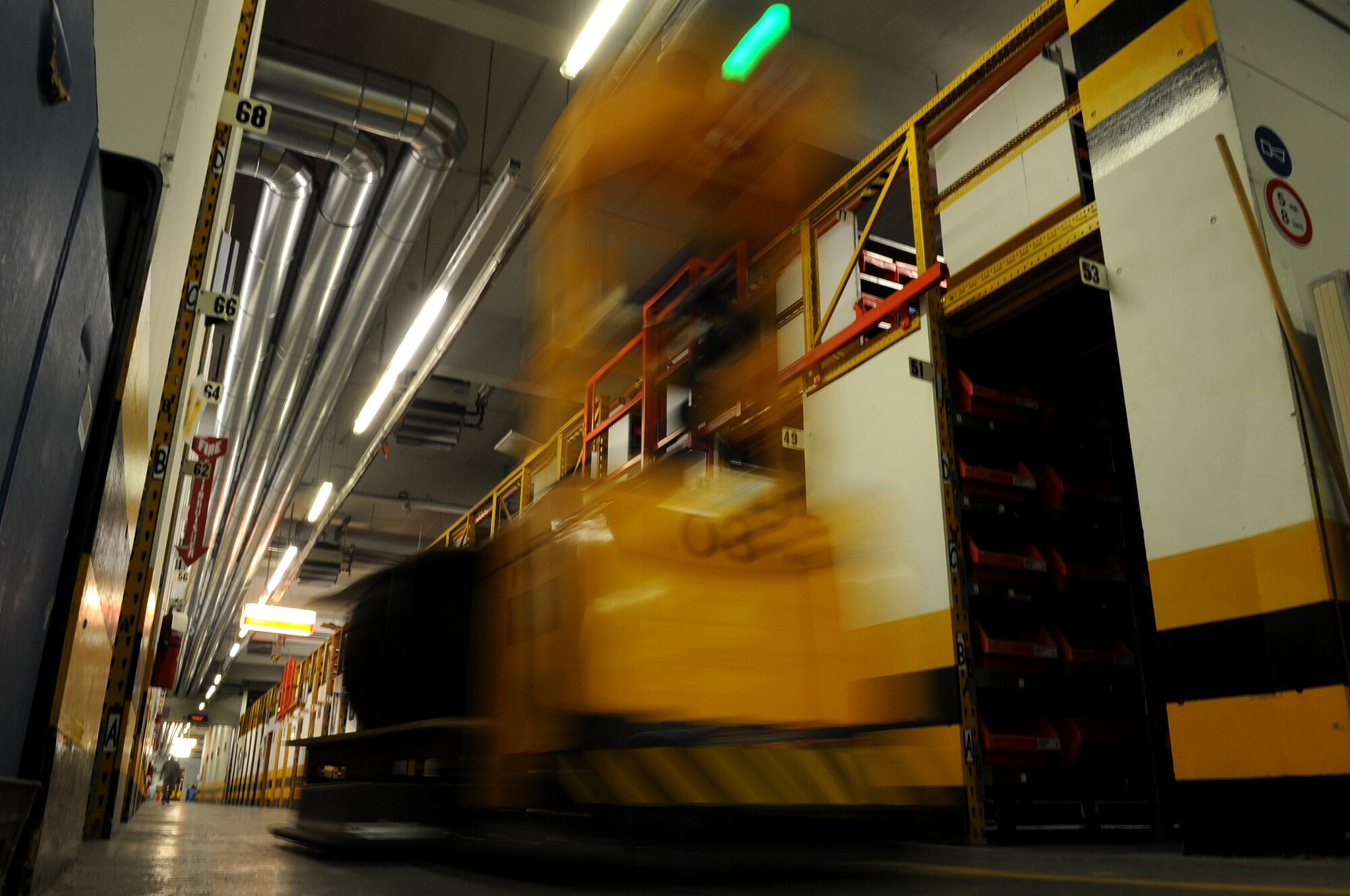An Automated Guided Vehicle drives itself to a directed location after being given a command by an operator during the showcase of the new equipment, Ramstein Air Base, Germany, June 17, 2010. The 86th Logistics Readiness Squadron material management flight are the first to ever use these AGVs in United States Air Forces in Europe. (U.S. Air Force photo by Airman 1st Class Grovert Fuentes-Contreras)(Released)