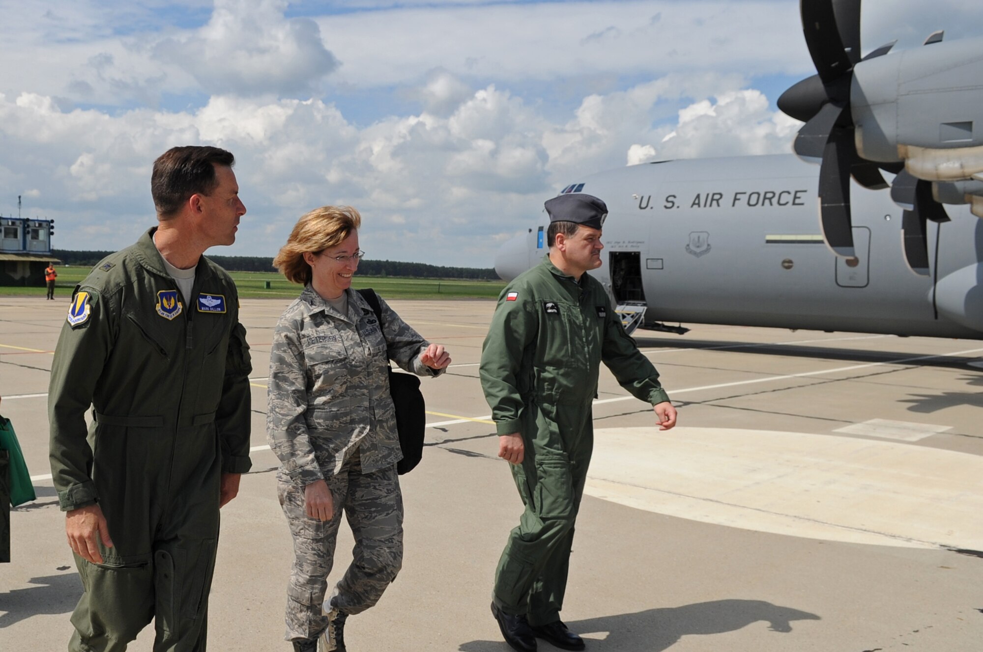 U.S. Air Force Brig. Gen. Mark Dillon, 86th Airlift Wing commander, Col. Mary Peterson, United States Air Attache to Poland, and Polish Air Force Brig. Gen. Tadeusz Mikutel, 3rd Airlift Wing commander, walk to a ceremony shortly after arriving on Powidz Air Base, Poland, June 21, 2010. The purpose of General Dillon's visit to Poland was to sign the letter designating the 86th AW and the 3rd Airlift Wing as 'sister wings' and to build partnerships. (U.S. Air Force photo by Airman 1st Class Grovert Fuentes-Contreras)(Released)
