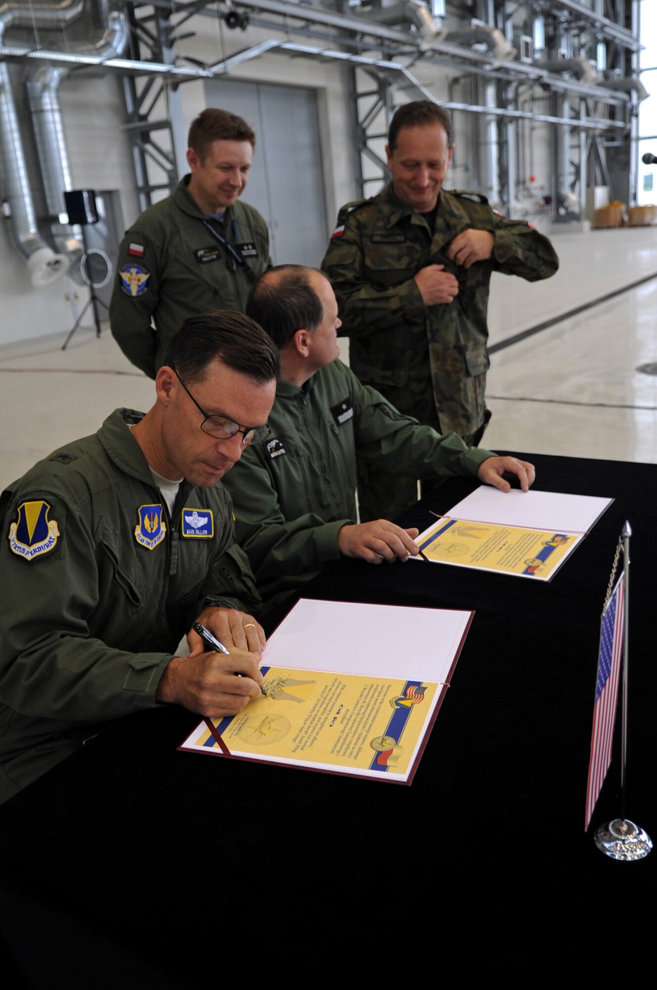 U.S. Air Force Brig. Gen. Mark Dillon, 86th Airlift Wing commander, signs a letter of intention during a ceremony held on Powidz Air Base, Poland, June 21, 2010. The purpose of General Dillon's visit to Poland was to sign the letter designating the 86th AW and the 3rd Airlift Wing as 'sister wings' and to build partnerships. (U.S. Air Force photo by Airman 1st Class Grovert Fuentes-Contreras)(Released)