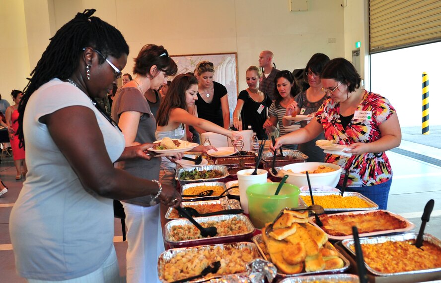 Spouses of deployed servicemembers gather at the Fire Department Headquarters for an evening of food, fellowship, and fun during the Deployed Spouses Dinner, Kadena Air Base, Japan, June 19. More than 90 spouses and 58 children attended the dinner hosted by the 18th Civil Engineer Group.   (U.S. Air Force photo/Tech. Sgt. Rey Ramon)  