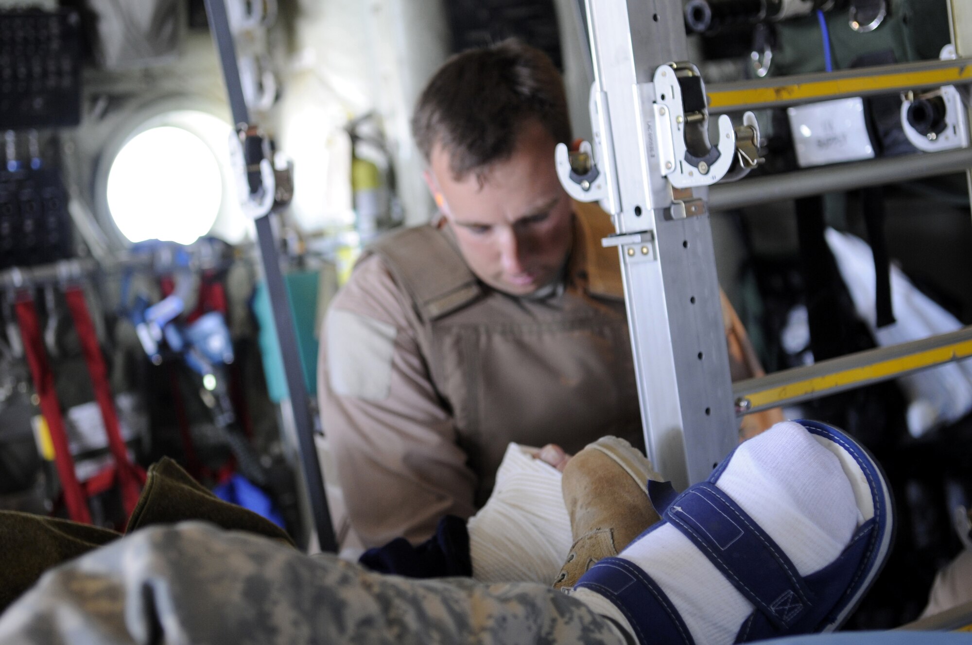 Tech. Sgt. Thomas Grantland, 451st Expeditionary Aeromedical Evacuation Squadron technician, secures the litter onto a C-130J Hercules after loading a patient June 9 at Kandahar Airfield, Afghanistan.  Sergeant Grantland is stationed at Pope AFB, N.C.  (U.S. Air Force photo by Senior Airman Nancy Hooks/Released)