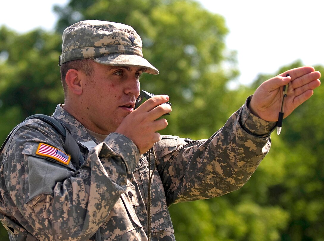 Spc. Derrick Schaible, a signal satellite communications specialist with the 738th Medical Company headquartered in Monticello, Ind., uses a compass to negotiate the land navigation course at the Camp Atterbury Joint Maneuver Training Center in central Indiana on June 18. The unit, part of the 81st Troop Command headquartered in Indianapolis, is conducting annual training at Camp Atterbury in preparation for a humanitarian aid mission to Haiti this fall.
