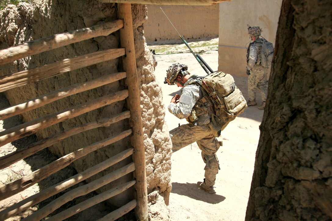 U.S. Army paratrooper communicate with other elements working with them during a mission in Charkh Valley, Logar province, Afghanistan, June 12, 2010.