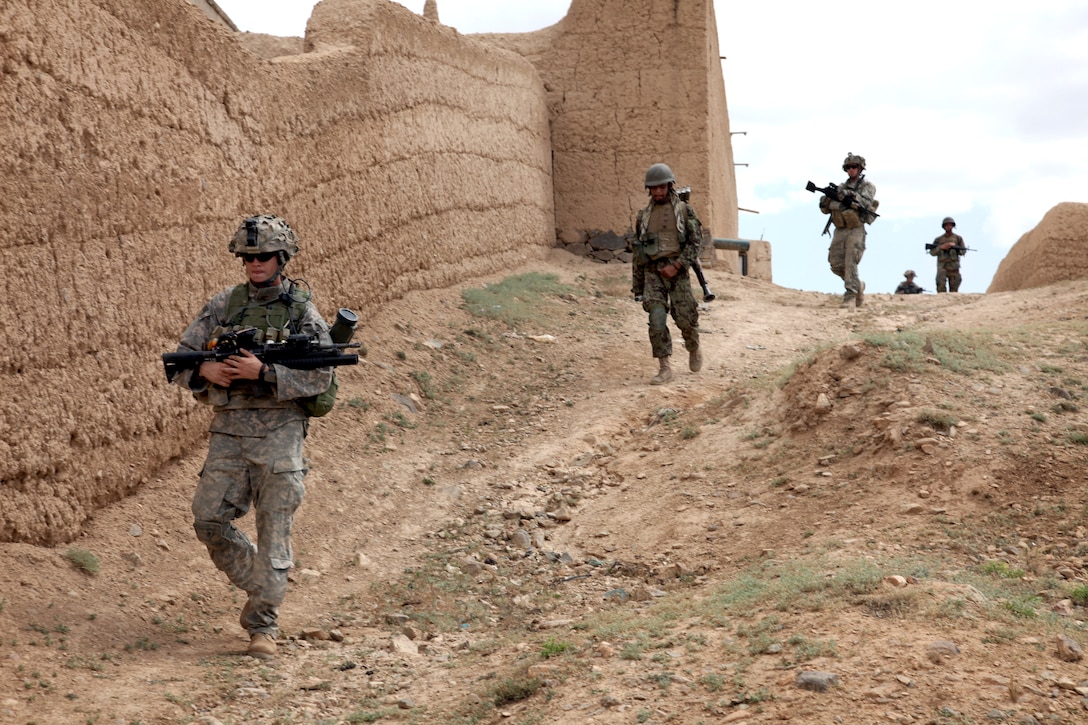 U.S. Army cavalrymen and Afghan National Army soldiers conduct a dismounted patrol through Charkh Valley, Logar province, Afghanistan, June 18, 2010.