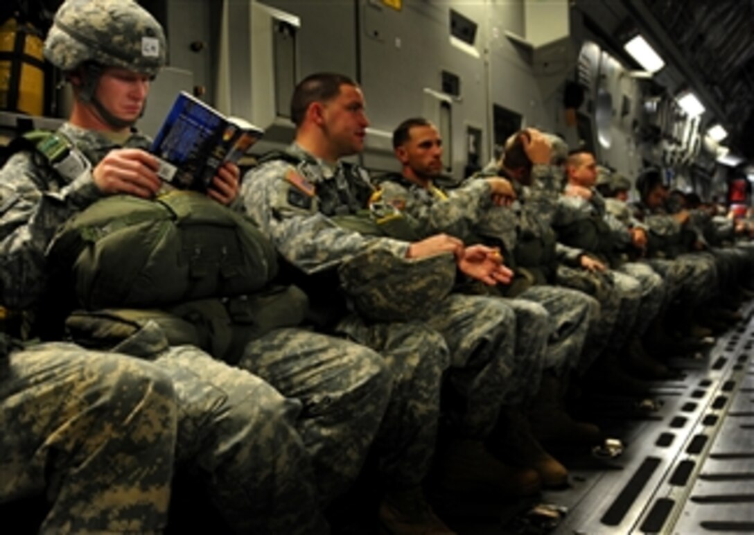 U.S. Army Pfc. Kyle Somerlot, with the 330th Transportation Brigade, reads a book aboard a C-17 Globemaster III cargo aircraft as he awaits his turn to perform an airborne insertion during a joint forcible entry exercise at Pope Air Force Base, N.C., on June 21, 2010.  A joint forcible entry exercise is a weeklong exercise conducted six times a year by soldiers from Fort Bragg and airmen at Pope that is designed to enhance cohesion between the Army and Air Force through large-scale heavy equipment and troop movements.  