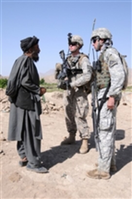 U.S. Army 1st Lt. Daniel Meegan (2nd from right), leader of 1st Platoon, Delta Company, 1st Battalion, 4th Infantry Regiment, U.S. Army Europe, and an Afghan interpreter (right) stop to question an Afghan man about Taliban activity while patrolling the area surrounding Forward Operating Base Baylough in Zabul province, Afghanistan, on June 18, 2010.  