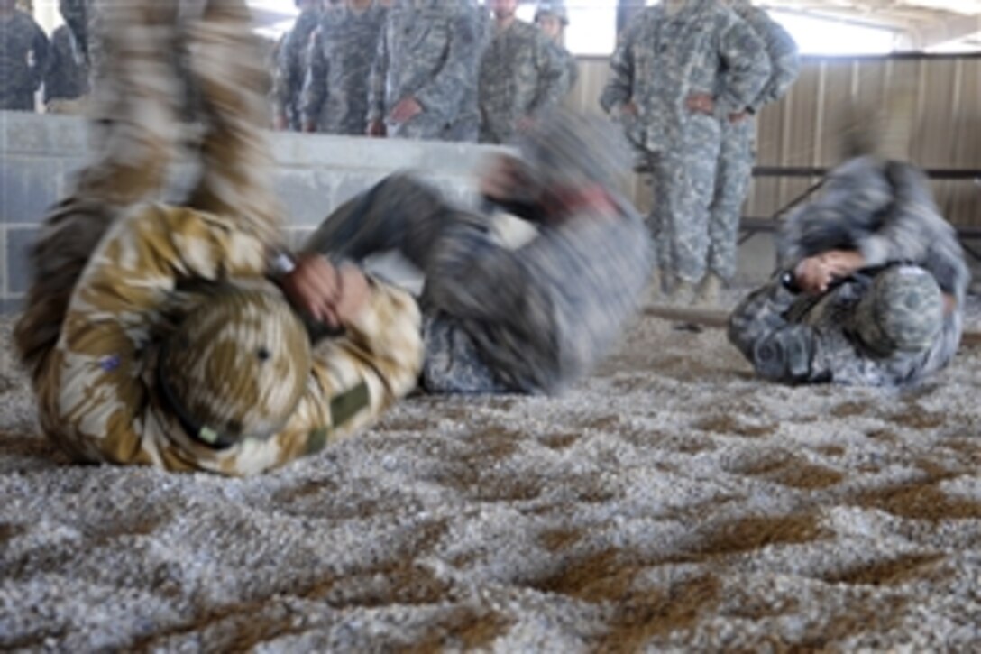 U.S. and British army paratroopers practice landing techniques during a forcible entry exercise on Pope Air Force Base, N.C., June 21, 2010. Soldiers from Fort Bragg, N.C., and airmen from Pope Air Force Base conduct the exercise six times a year to enhance cohesion between the Army and Air Force.
