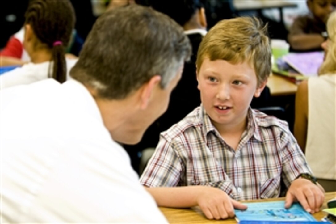 Education Secretary Arne Duncan speaks with a child at Fort Belvoir Elementary School, Va., June 22, 2010. 