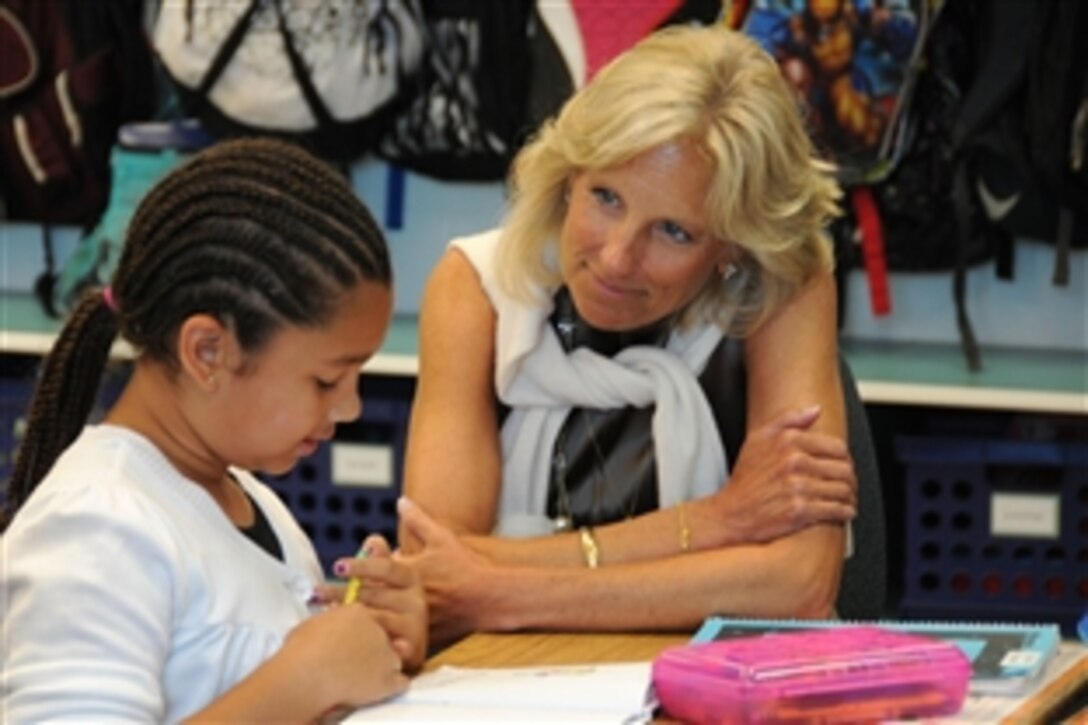 A second grade student from Fort Belvoir Elementary School, Va., reads her assignment to Dr. Jill Biden, wife of Vice President Joe Biden, June 22, 2010. 