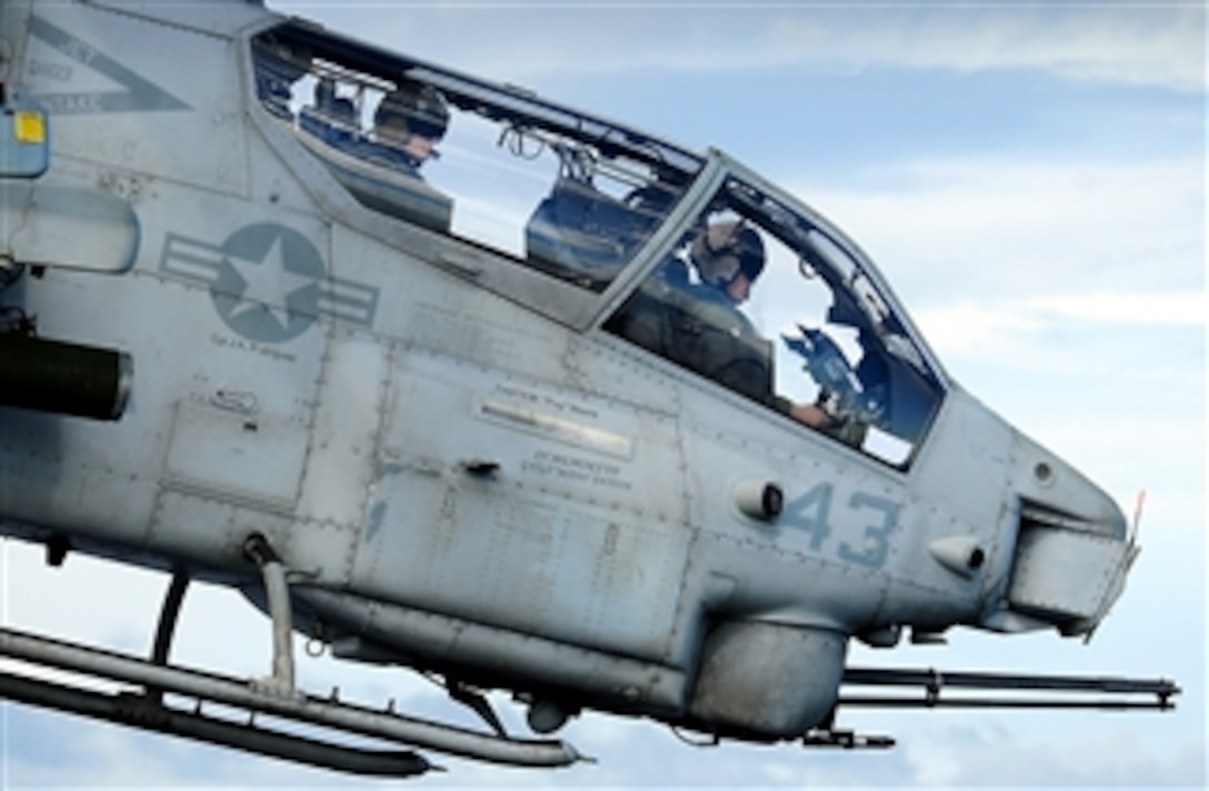 U.S. Marine Corps pilots assigned to the 15th Marine Expeditionary Unit fly an AH-1W Super Cobra helicopter during flight operations aboard the amphibious assault ship USS Peleliu (LHA 5) while underway in the Pacific Ocean on June 17, 2010.  