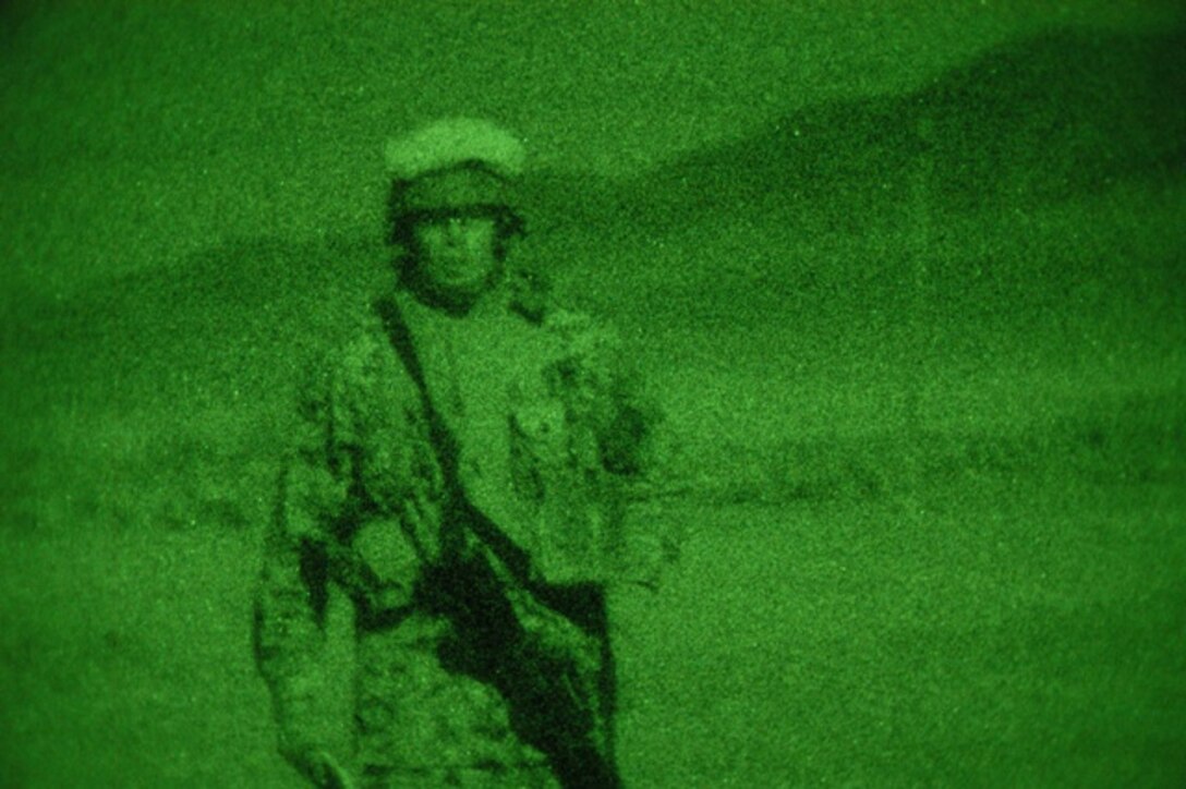 A Marine from 2nd Platoon, Company I, 3rd Battalion, 23rd Marine Regiment, walks toward the gate as his platoon leaves for a night patrol June 23, 2010 at Hilton Ranch, Nev., as part of the final exercise of Javelin Thrust 2010.  Company I went on a security patrol after their base was hit by simulated mortar fire.