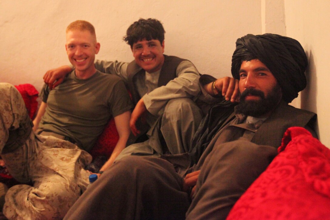 Abdul Gunny, Kharshma, and Cpt. Phillip Noack, a civil affairs team leader with 1st Battalion, 2nd Marine Regiment, Regimental Combat Team 2, pose for a picture during a party with Afghan National Police and Marines, June 23. Noack, who will be leaving Musa Qal’eh, was the guest of honor. The party began with a meal of beans, rice, beef, and French fries. After the meal, a few of the ANP played live music and Abdual Gunny sang. The ANP and Marines were having a good time and even danced to the music. The friendships created through interactions like this will help the Afghan police force and Marines work better together.  ::r::::n::(Official U.S. Marine Corps photo by Cpl. Ned Johnson)