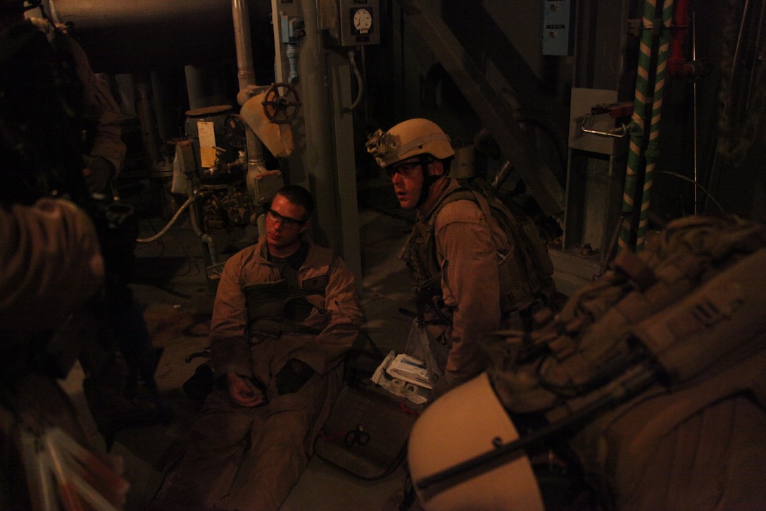 A hospital corpsman with 26th Marine Expeditionary Unit Unit’s Maritime Interception Operation raid force assesses a simulated casualty during a Maritime Interception Operation exercise at a training facility in Barnwell, S.C., June 23, 2010. 26th MEU Unit’s Maritime Interception Operation raid force conducted the three-day exercise in preparation for deployment this fall. The exercise hones the MEU’s ability to swiftly control the operation of a hostile ship or maritime platform. (Official USMC Photo by Lance Cpl. Santiago G. Colon Jr.)::r::::n::