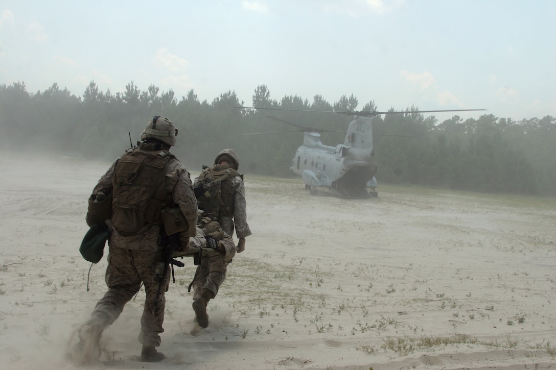 Petty Officer 2nd Class Cody T. West, a corpsman with Company A, 2nd Assault Amphibian Battalion,  and a Marine with Co. A, 2nd AA Bn., evacuate a casualty at landing zone Cardinal during the Mission Rehearsal Exercise, June 22. Special-purpose Marine Air-Ground Task Force Continuing Promise 2010 conducted a MRX from June 21-23 to demonstrate the level of unit readiness for the upcoming four-month deployment to Central and South American countries.